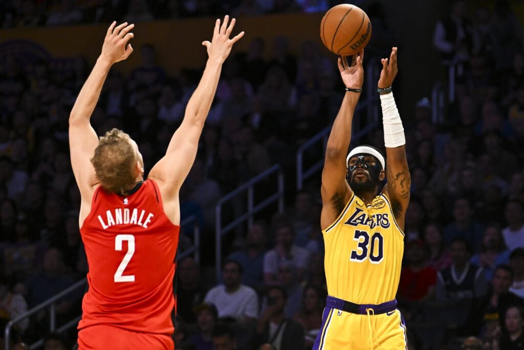 Apr 11, 2025; Los Angeles, California, USA; Los Angeles Lakers guard Jordan Goodwin (30) shoots against Houston Rockets center Jock Landale (2) during the first half at Crypto.com Arena. Mandatory Credit: Jonathan Hui-Imagn Images
