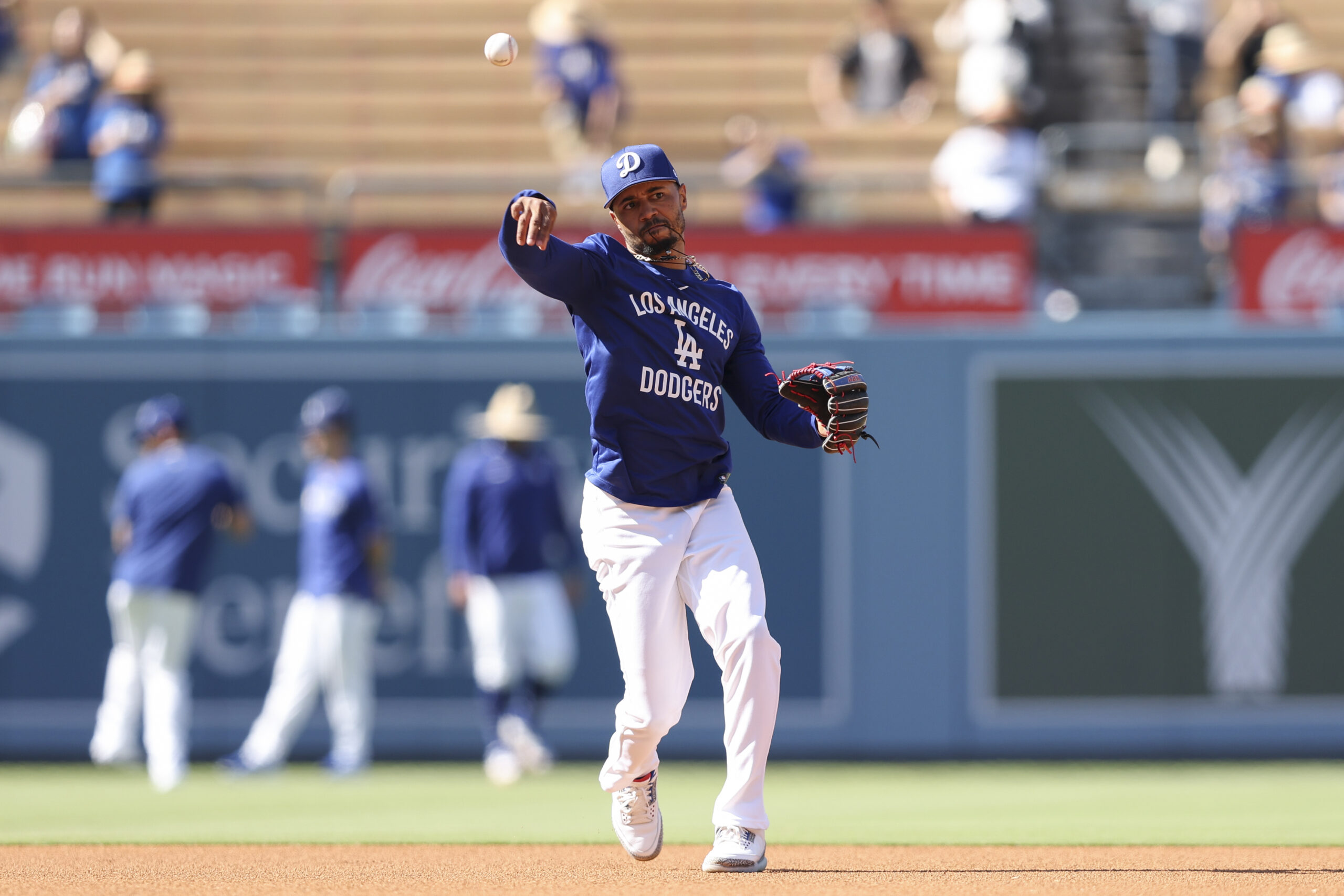 Los Angeles Dodgers shortstop Mookie Betts throws to first base...