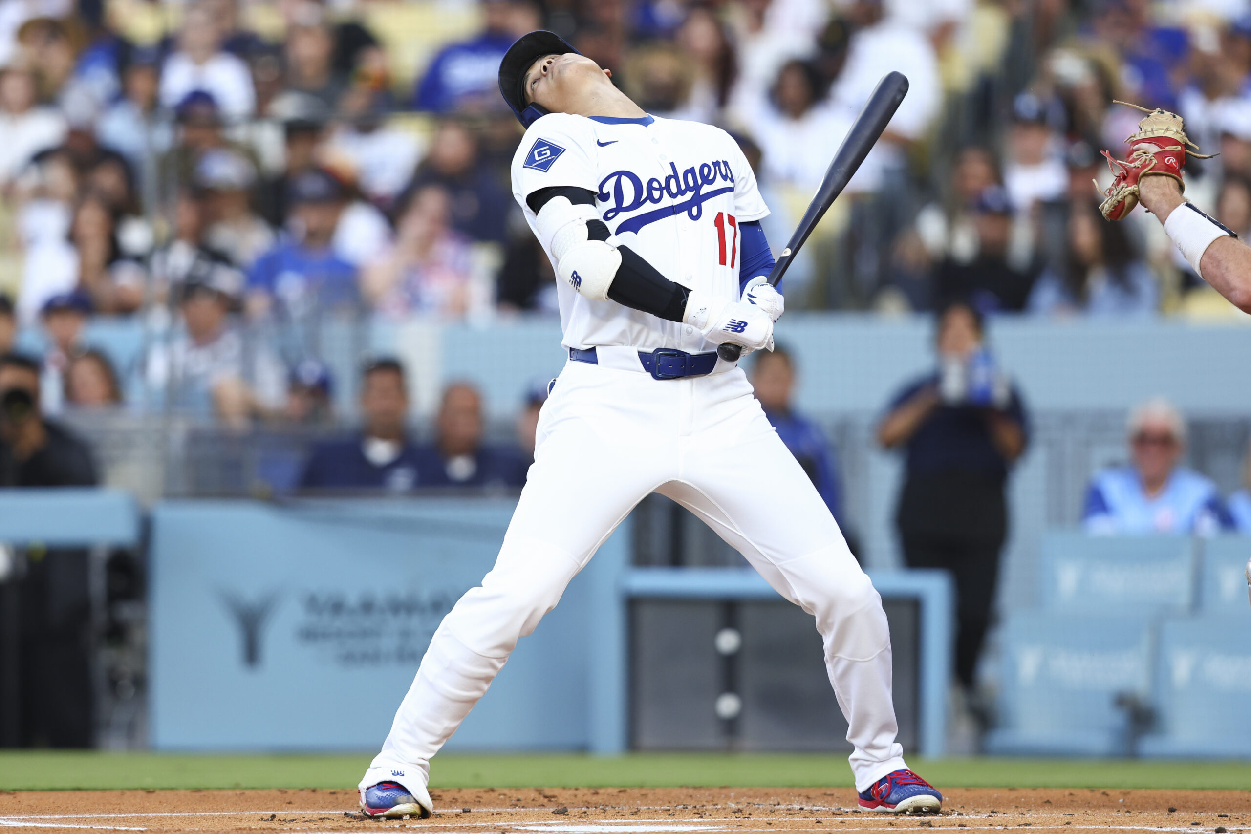 Dodgers star Shohei Ohtani avoids a pitch during the first...
