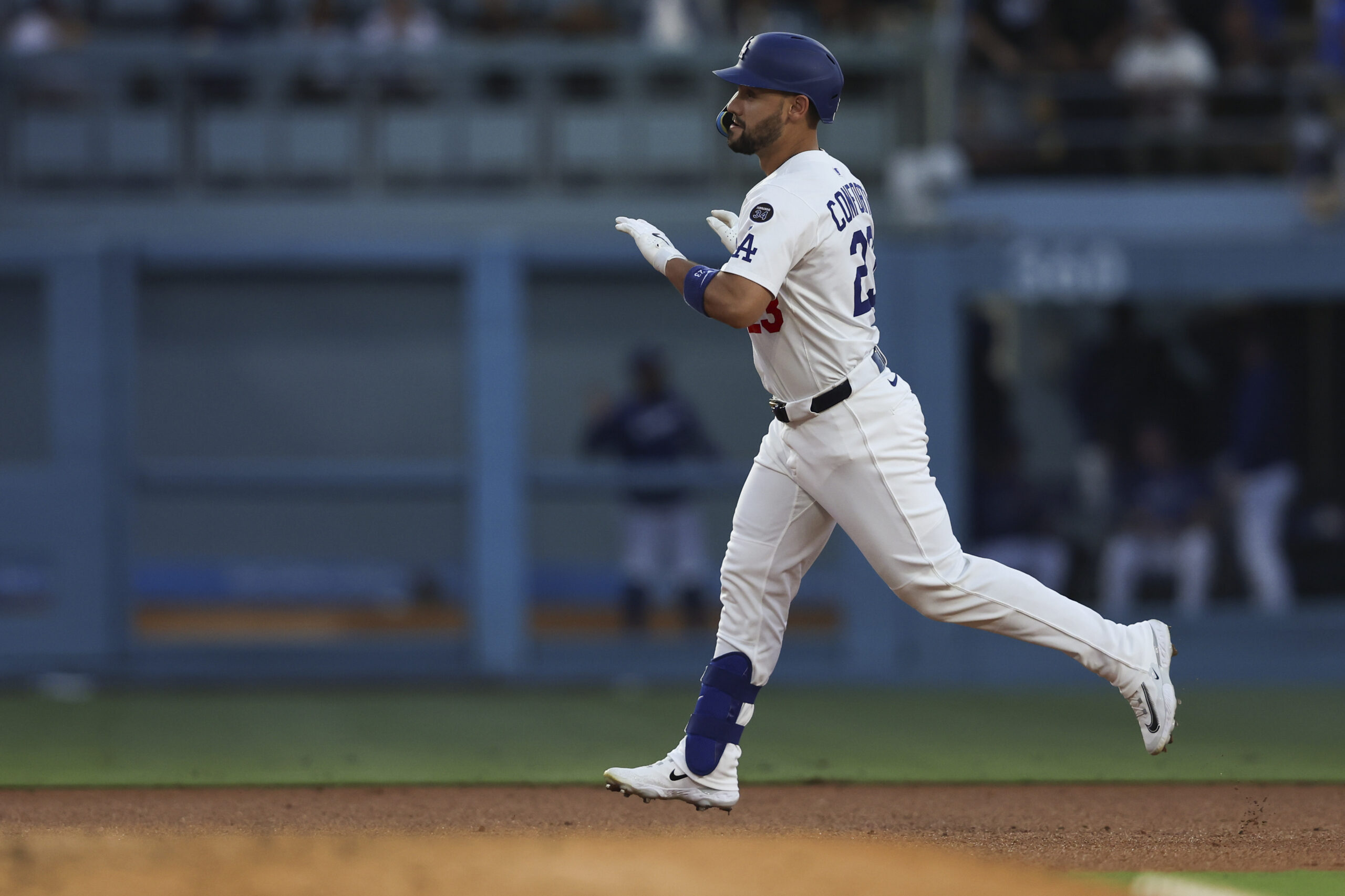 The Dodgers’ Michael Conforto gestures while running the bases after...