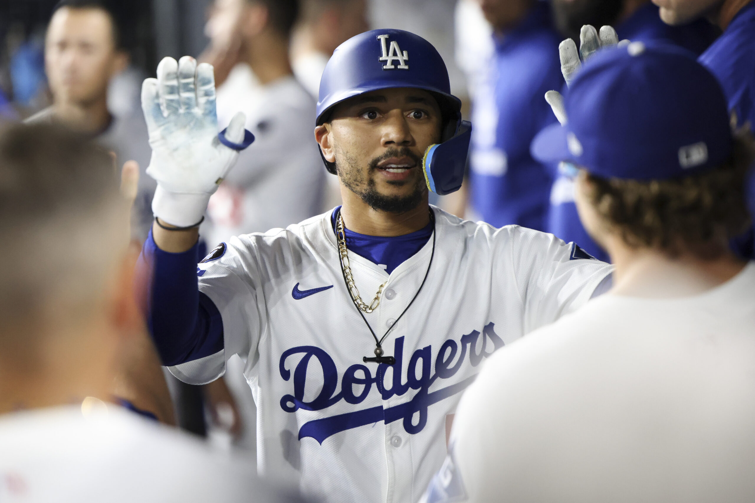 The Dodgers’ Mookie Betts celebrates in the dugout with teammates...