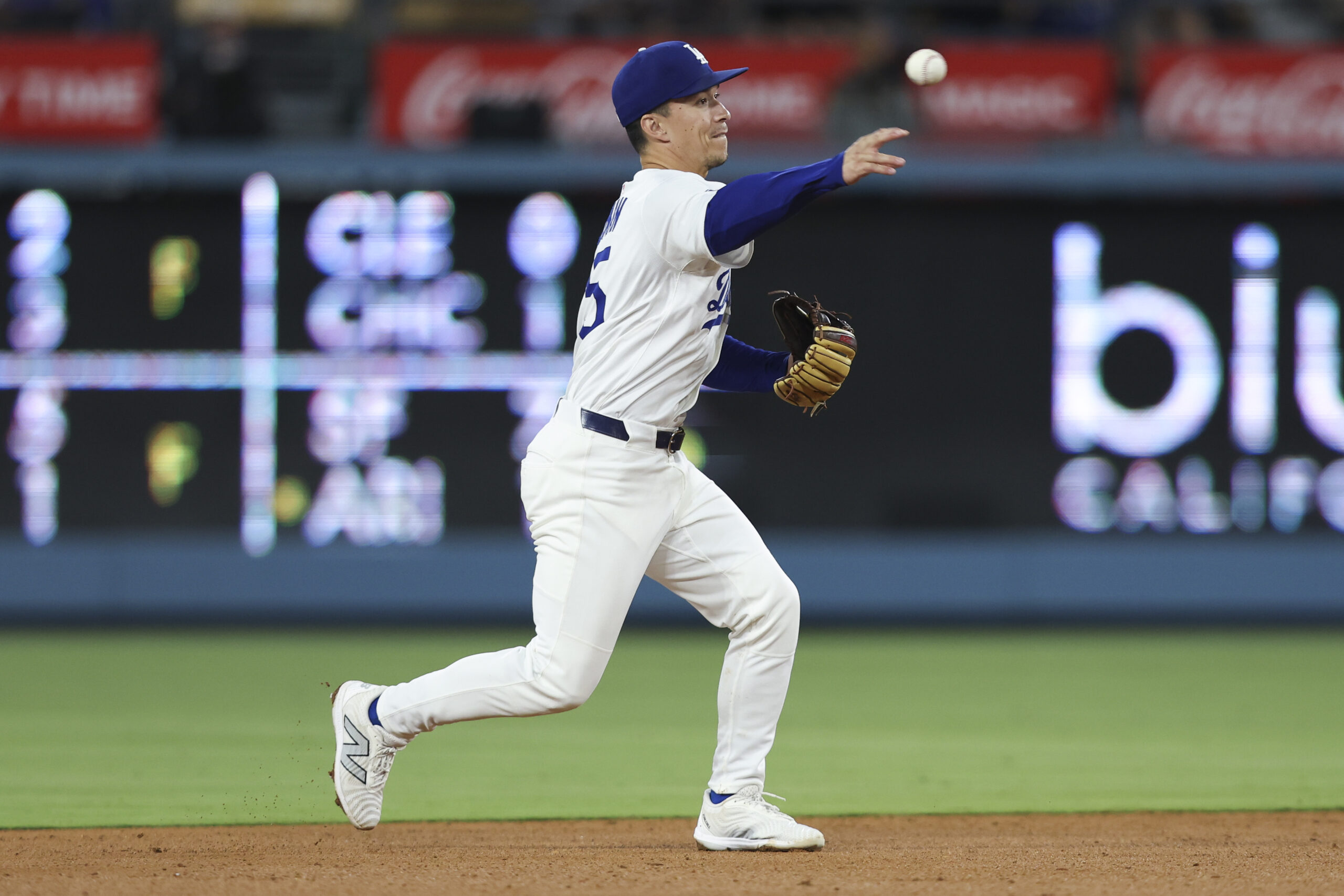 Dodgers second baseman Tommy Edman throws to first base during...