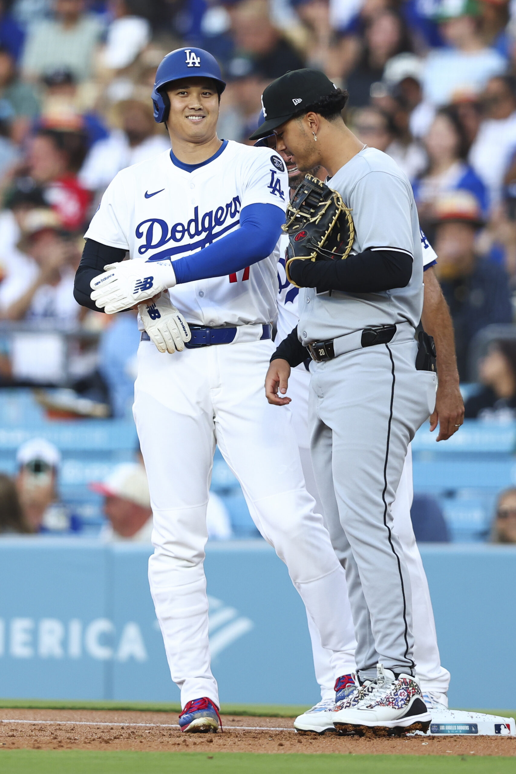 Dodgers star Shohei Ohtani, left, interacts with Chicago White Sox...