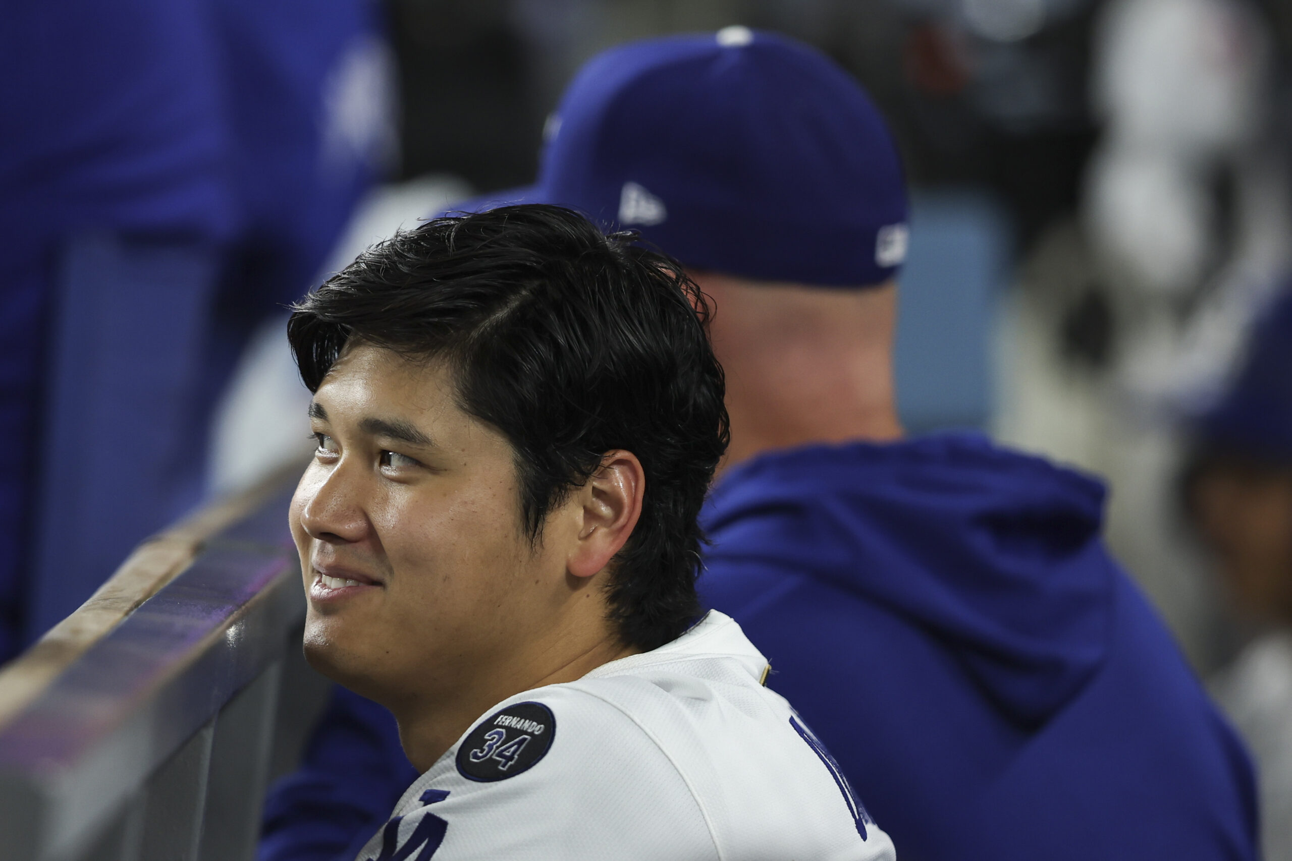 Dodgers star Shohei Ohtani reacts in the dugout during the...