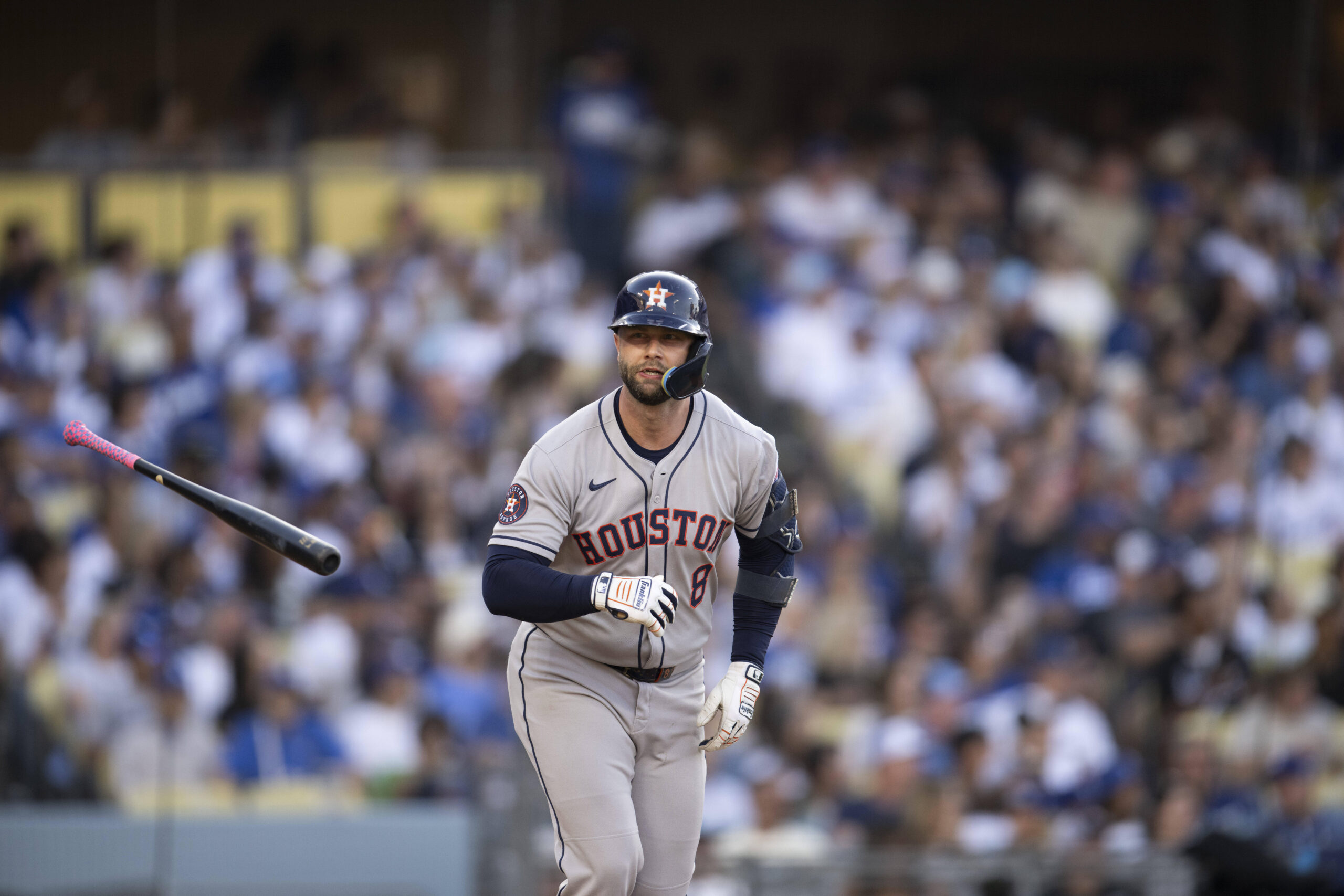Houston Astros’ Christian Walker flips his bat after hitting a...