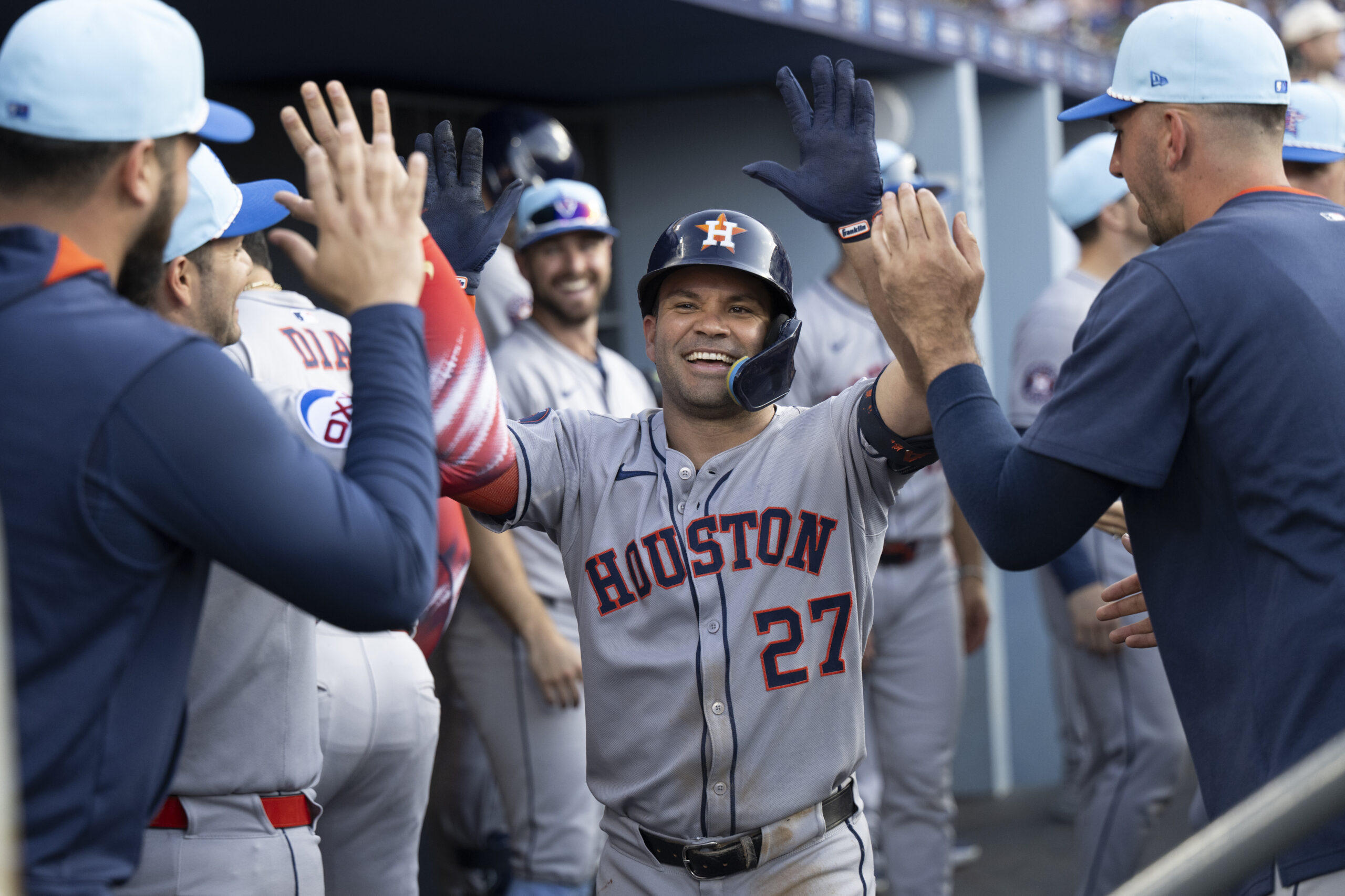 Houston Astros’ Jose Altuve, center, celebrates in the dugout after...