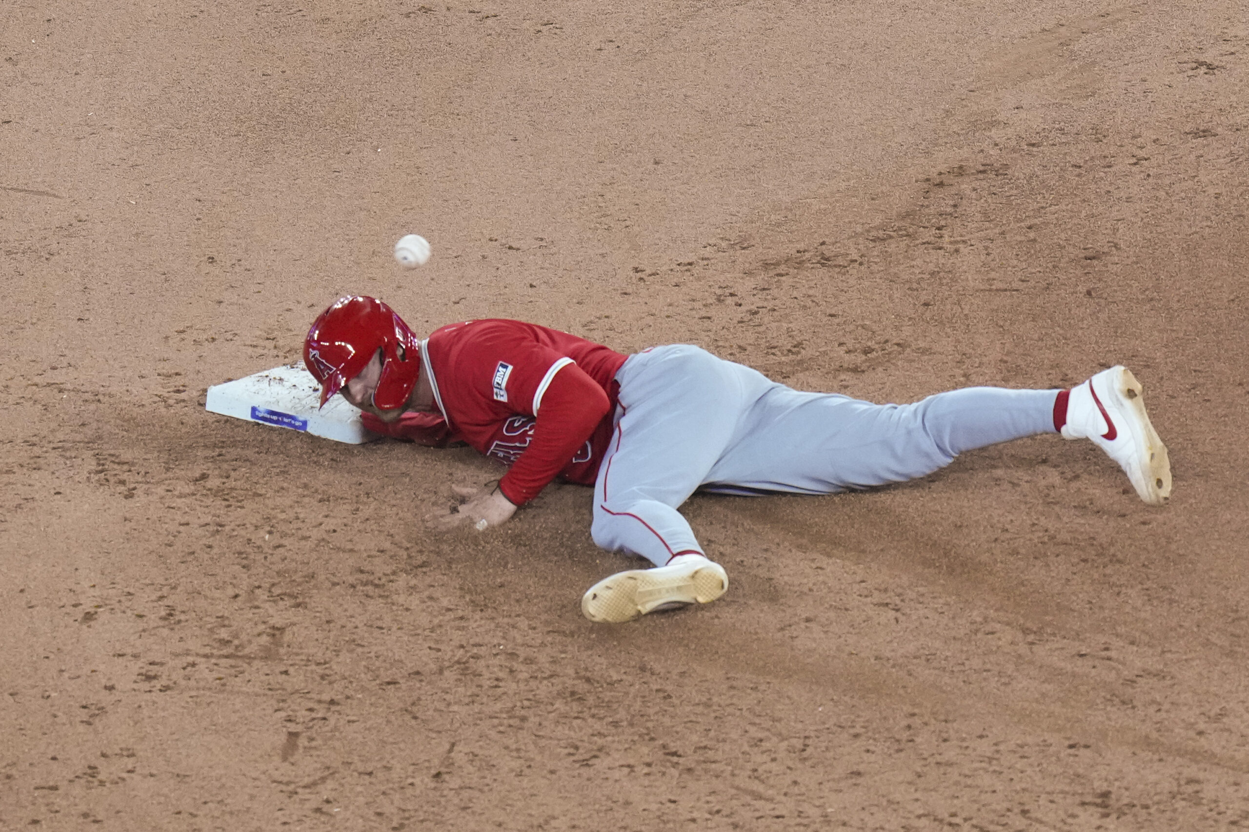 Angels’ Taylor Ward safely tags back into second base during...