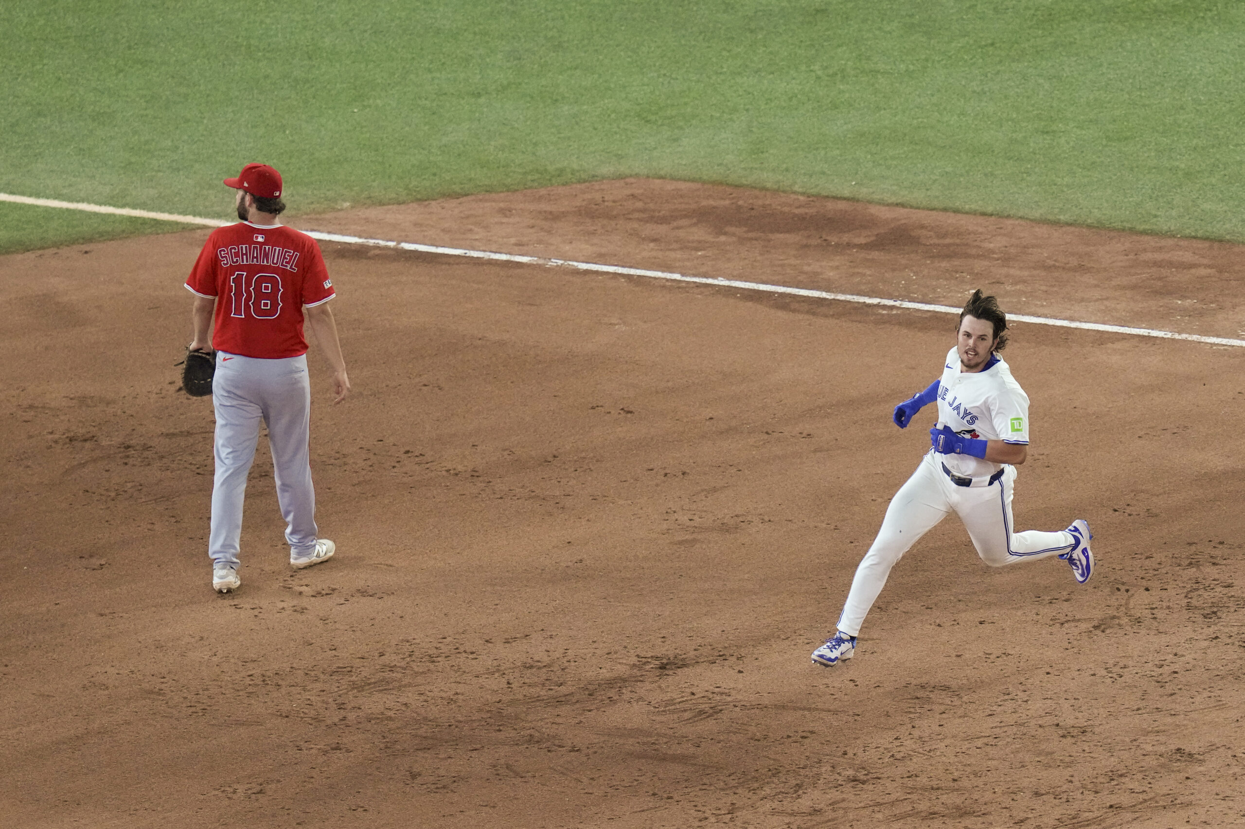 Toronto Blue Jays’ Addison Barger, right, runs past Angels first...