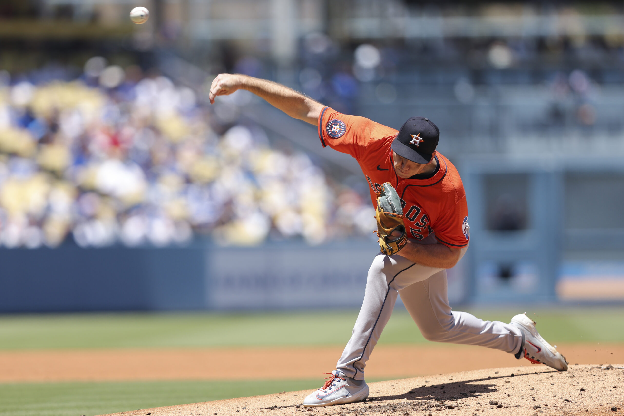 Houston Astros pitcher Ryan Gusto delivers to a Dodgers batter...
