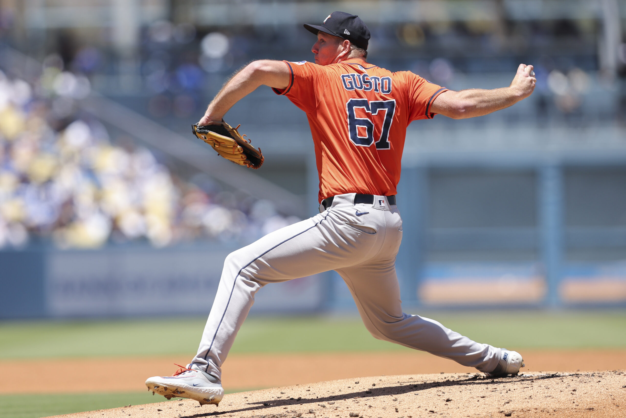 Houston Astros pitcher Ryan Gusto throws to a Dodgers batter...
