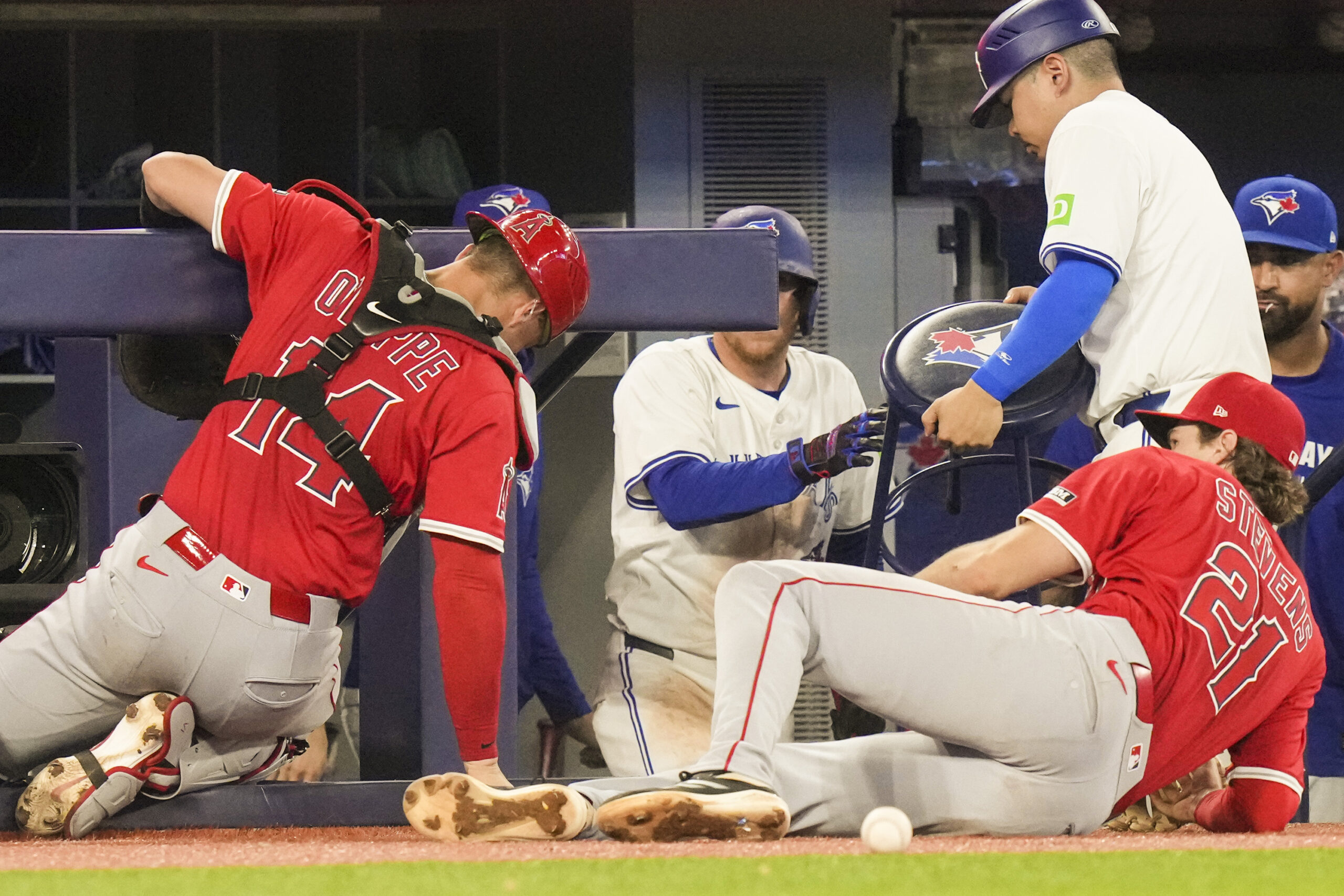 Angels catcher Logan O’Hoppe (14) clings to the Toronto Blue...