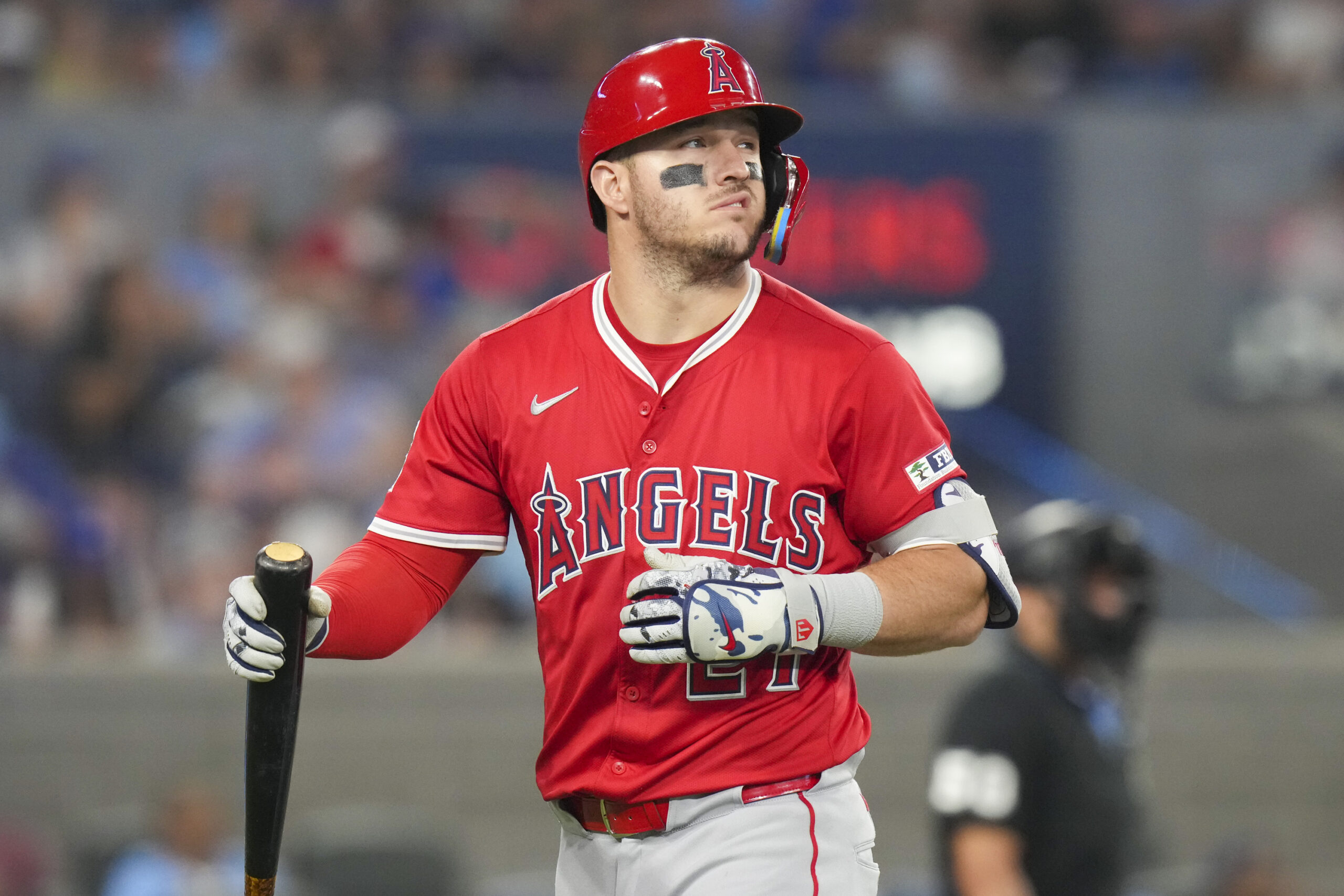 Angels designated hitter Mike Trout reacts after being struck out...