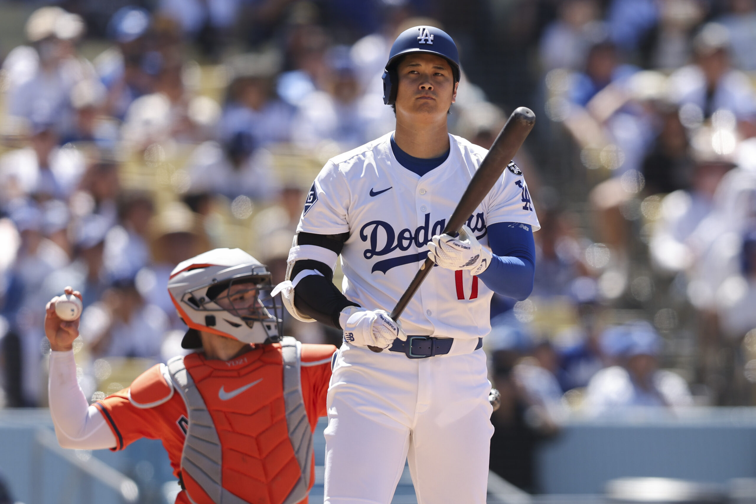 Dodgers designated hitter Shohei Ohtani, right, looks on as Houston...