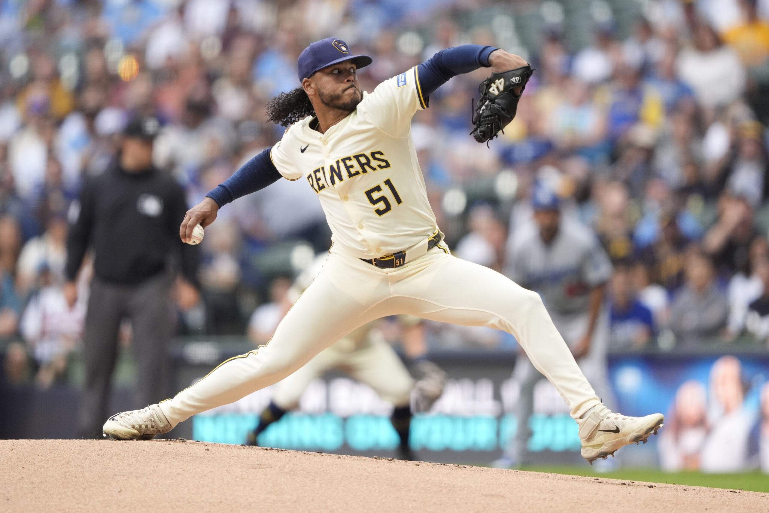 Milwaukee Brewers starting pitcher Freddy Peralta throws to the plate...