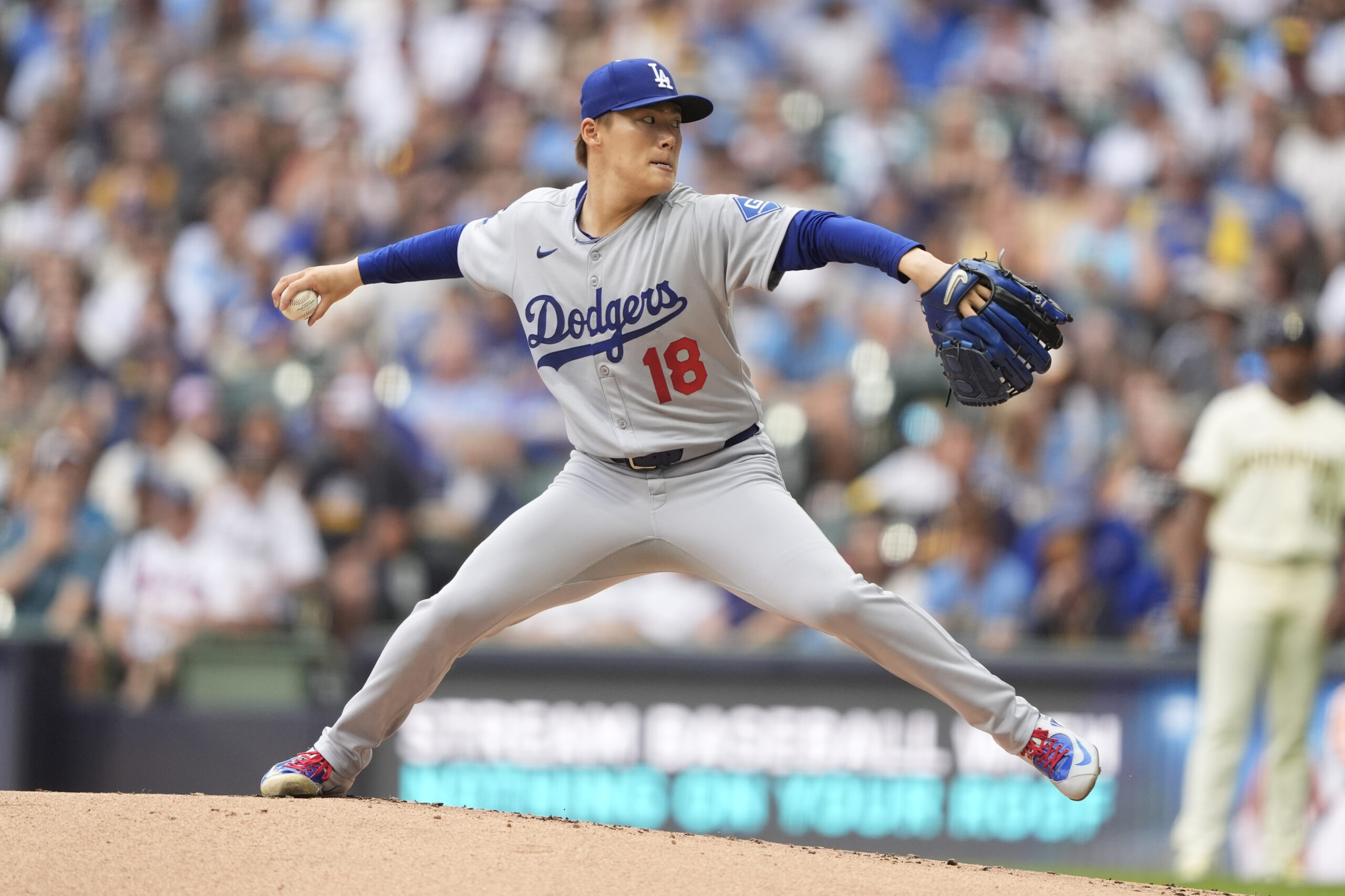 Dodgers starting pitcher Yoshinobu Yamamoto throws to the plate during...