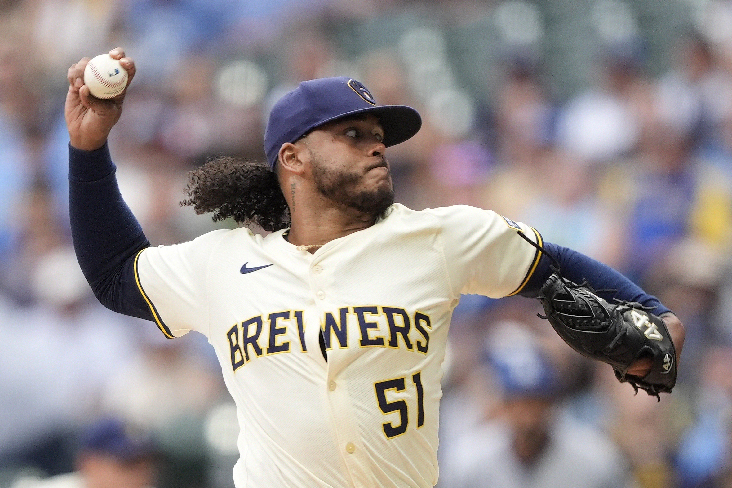 Milwaukee Brewers starting pitcher Freddy Peralta throws to the plate...