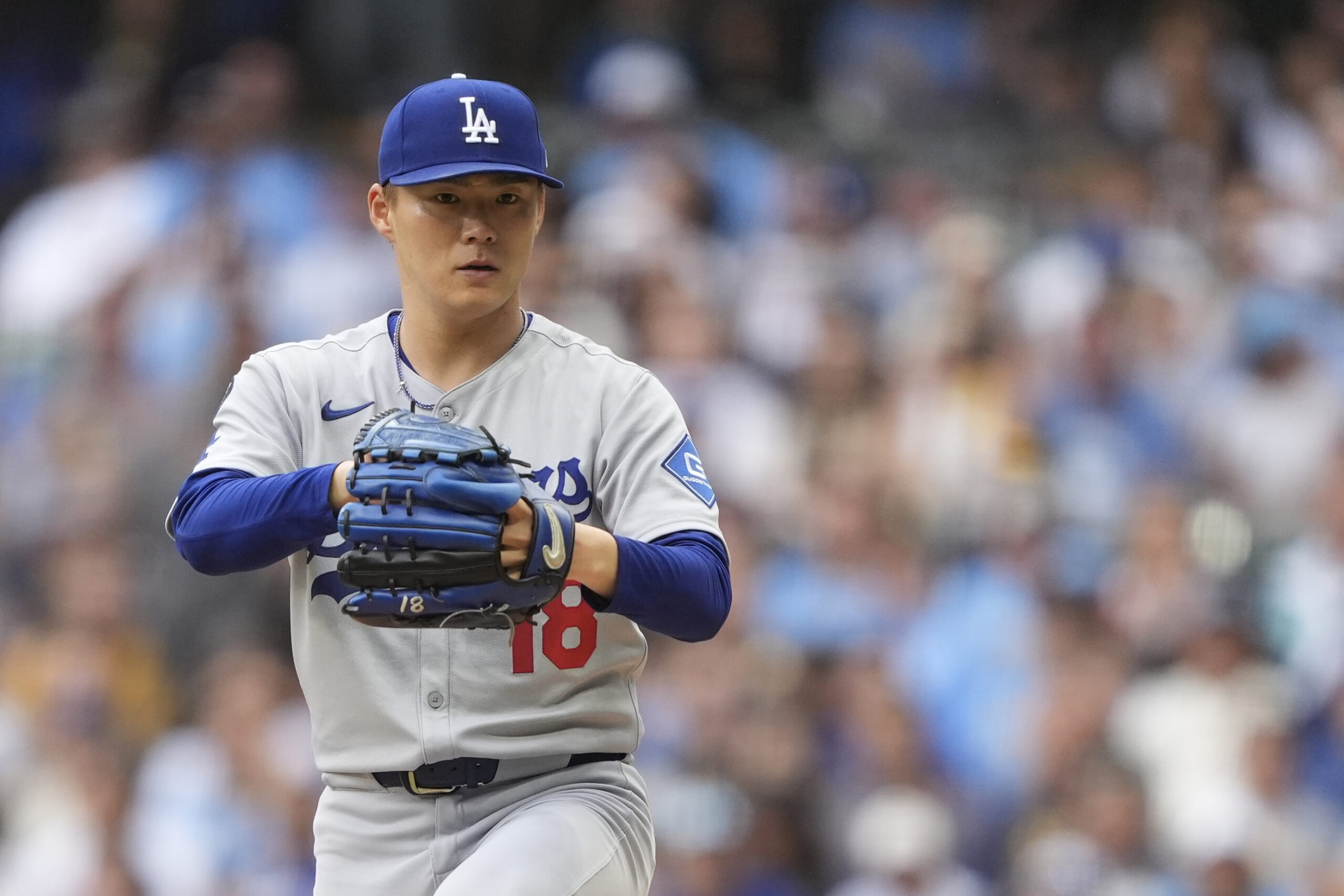 Dodgers starting pitcher Yoshinobu Yamamoto prepares to throw to the...