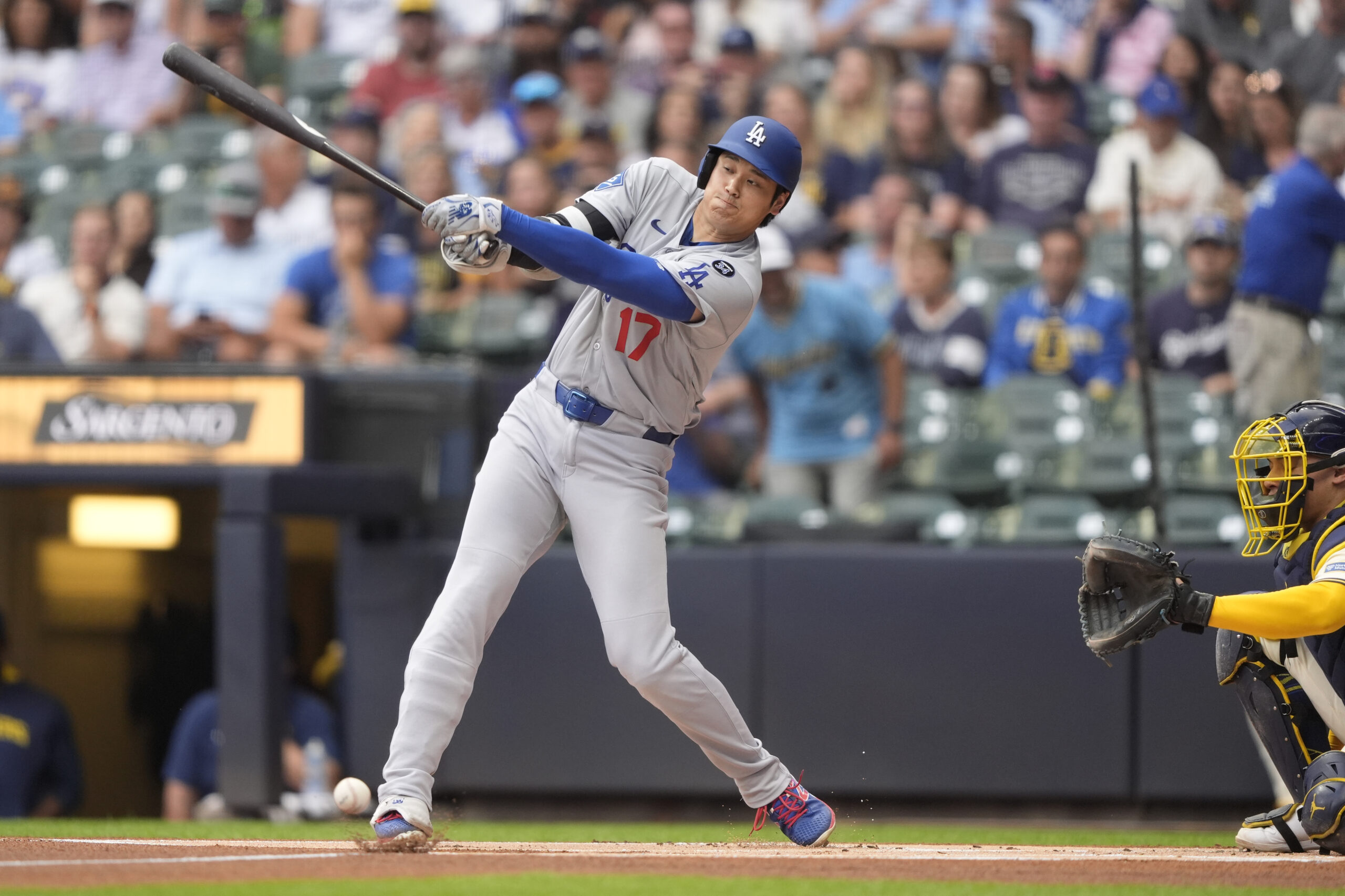 Dodgers star Shohei Ohtani hits an infield single during the...