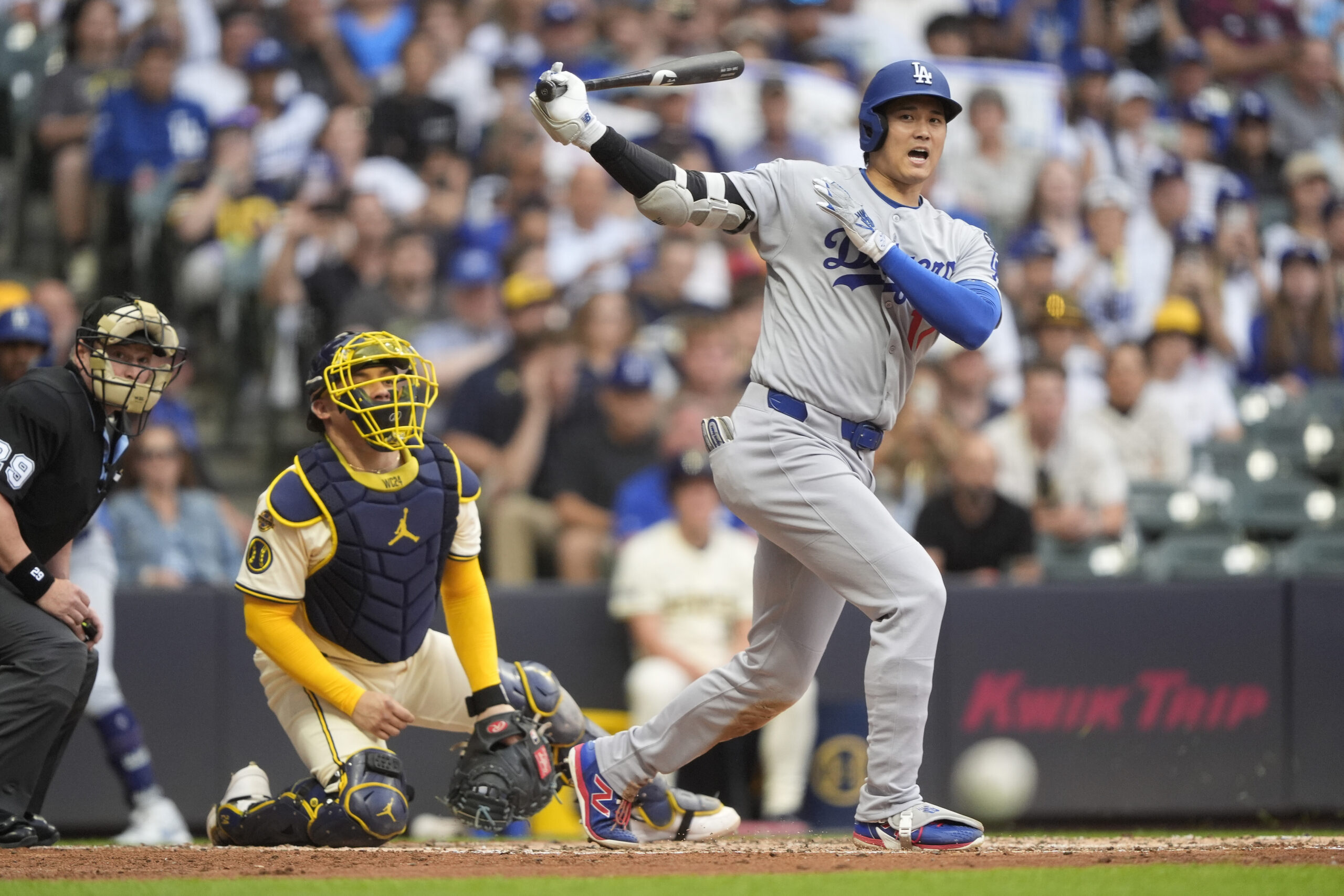Dodgers star Shohei Ohtani reacts after hitting a foul ball...