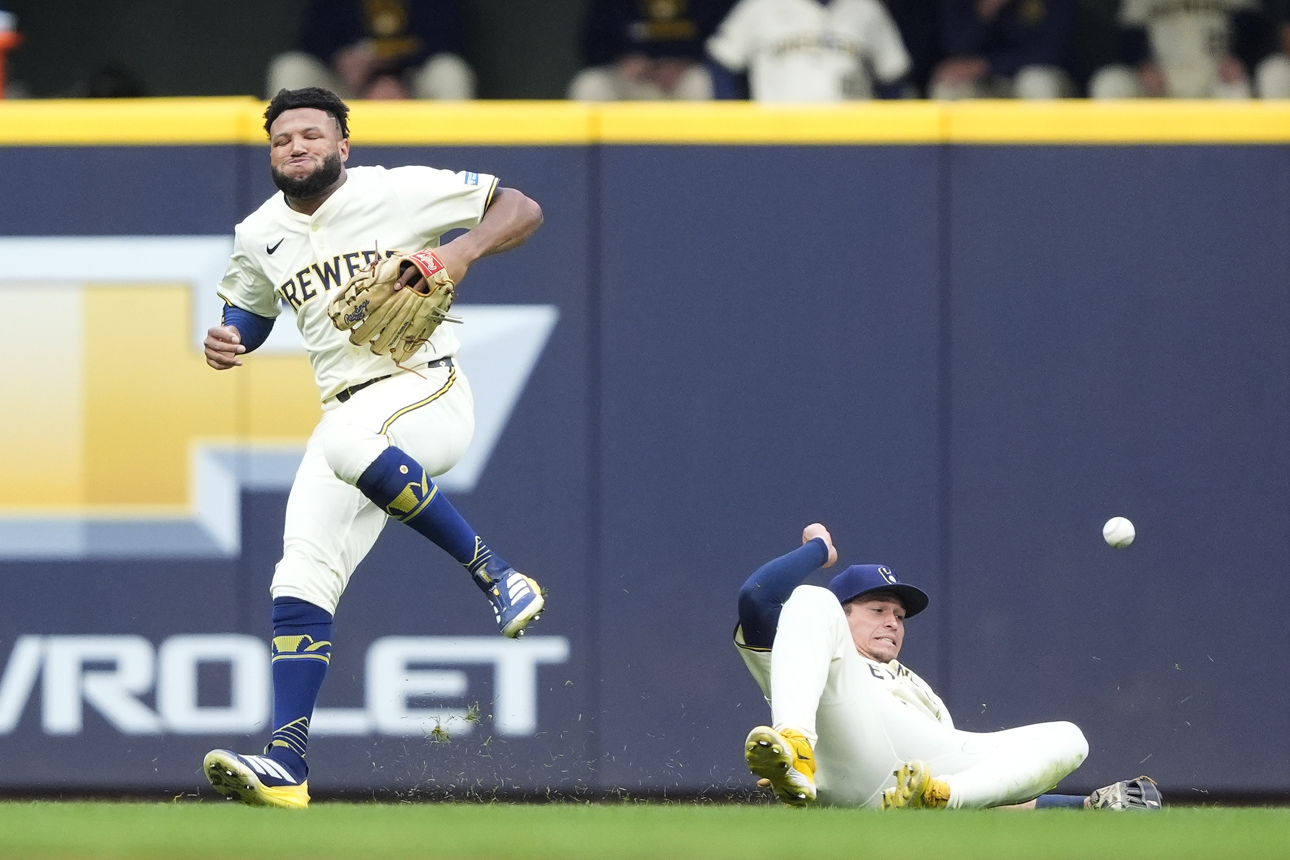 Milwaukee Brewers outfielders Jackson Chourio, left, and Isaac Collins, right,...