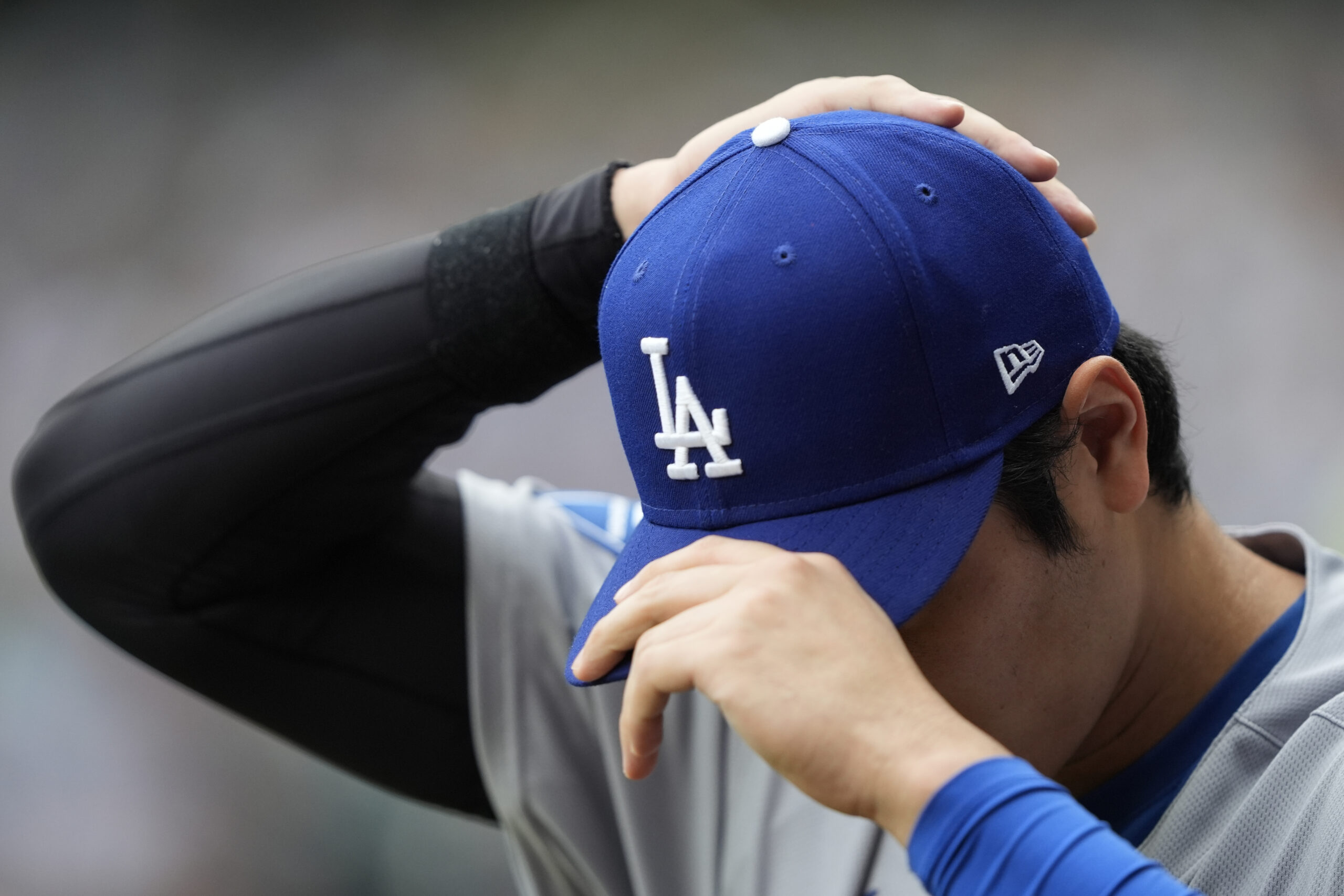 Dodgers star Shohei Ohtani adjusts his cap before a baseball...