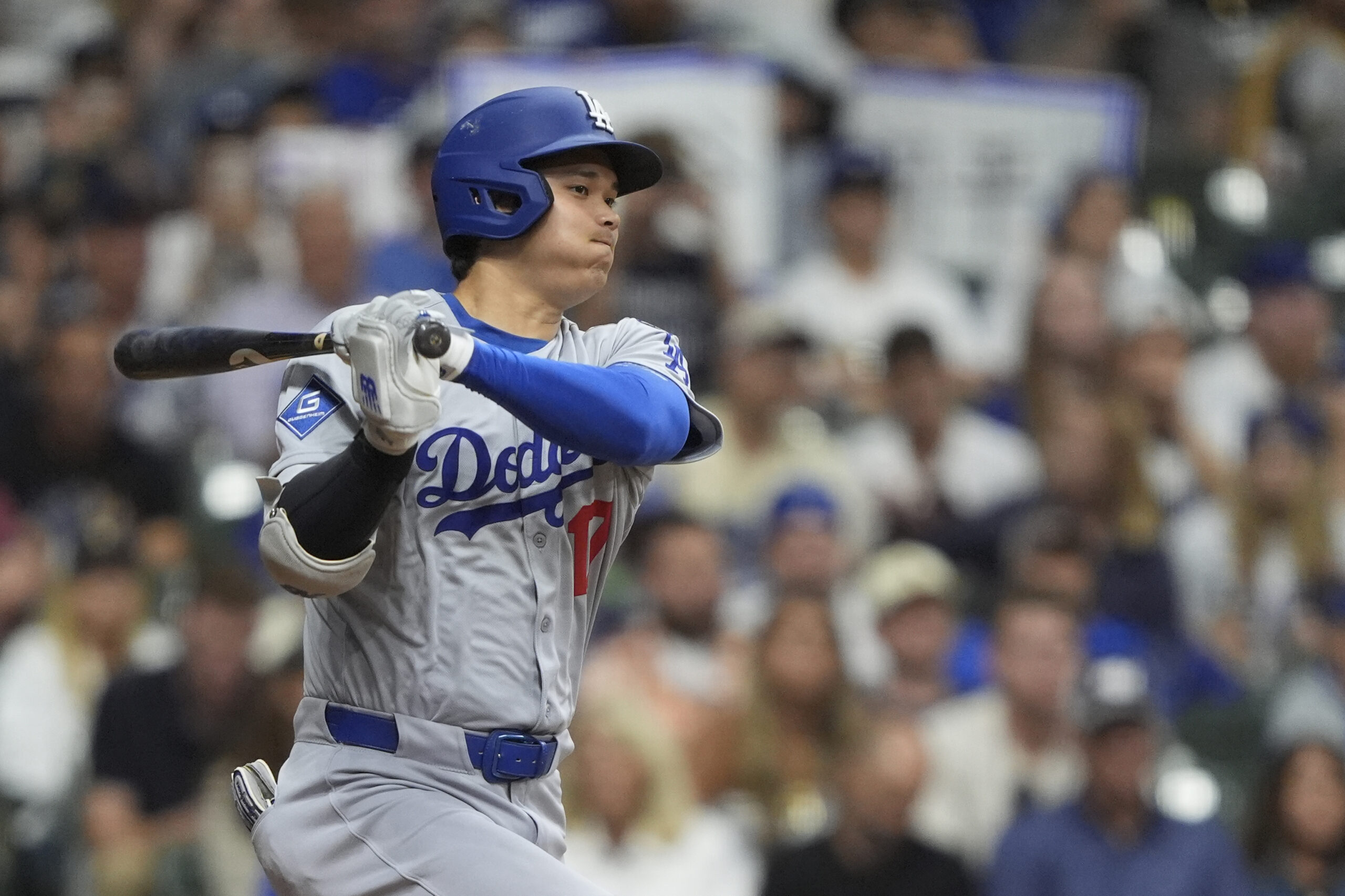 Dodgers star Shohei Ohtani hits a single during the eighth...