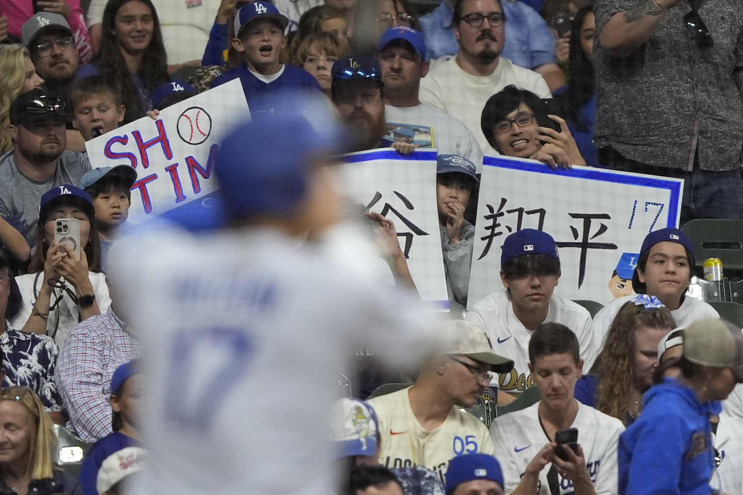 Fans cheer as Dodgers star Shohei Ohtani bats during the...