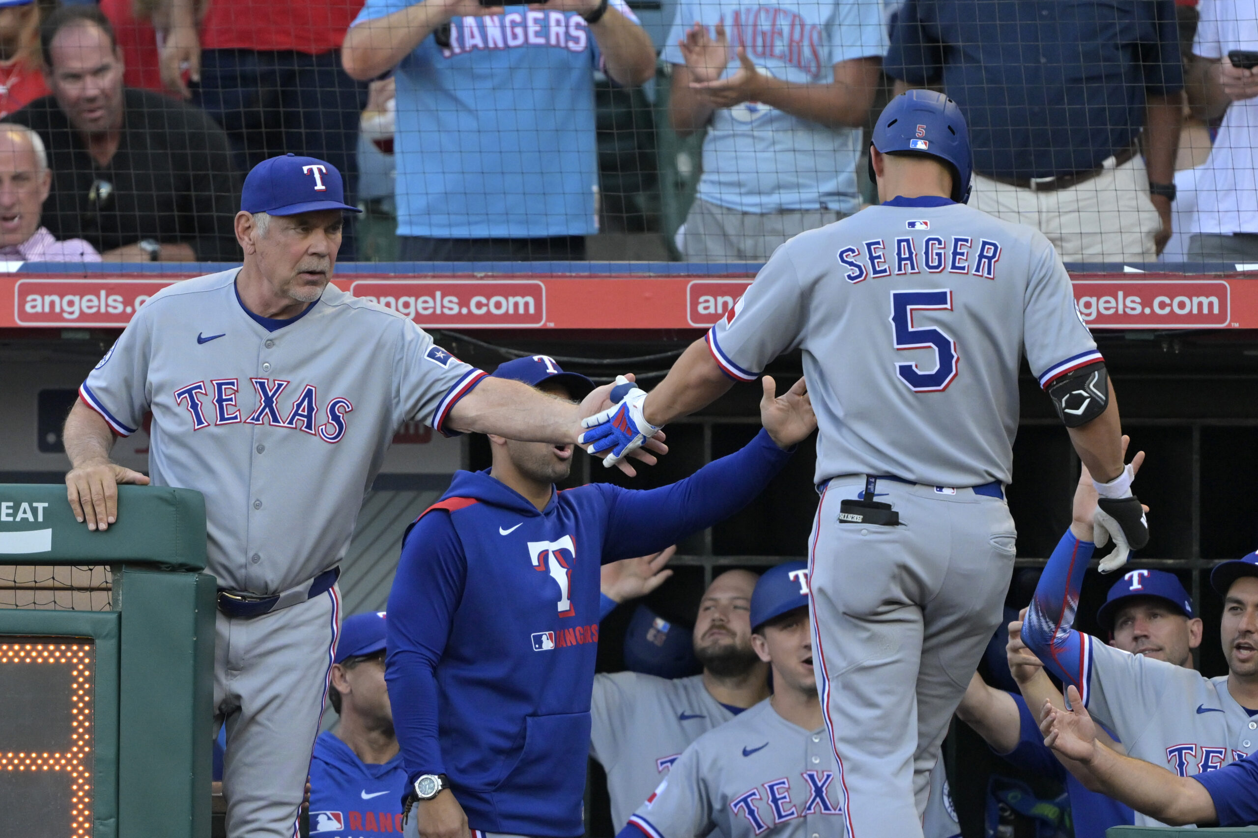 The Texas Rangers’ Corey Seager (5) is greeted by Manager...