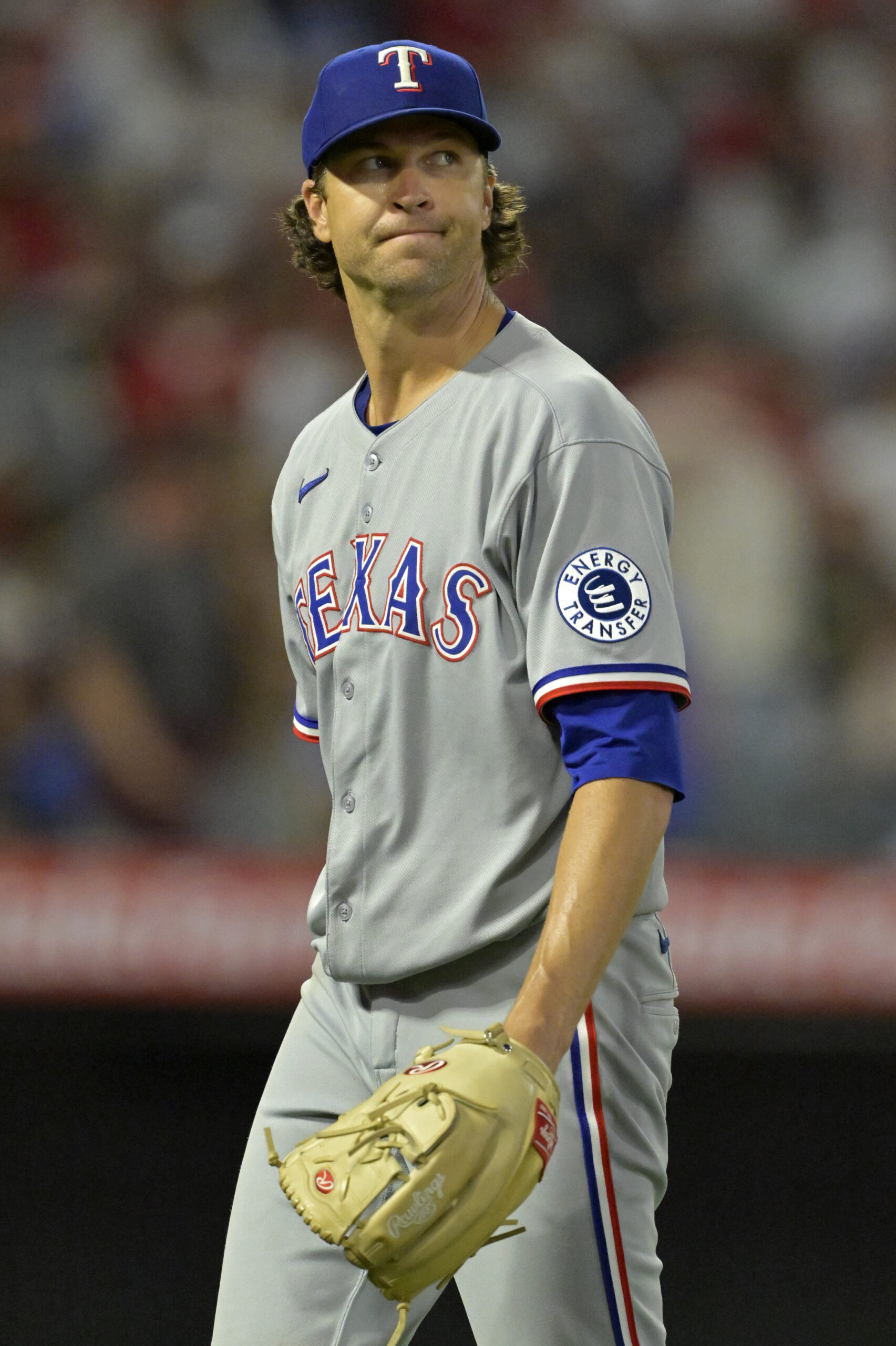Texas Rangers starting pitcher Jacob deGrom walks off the mound...