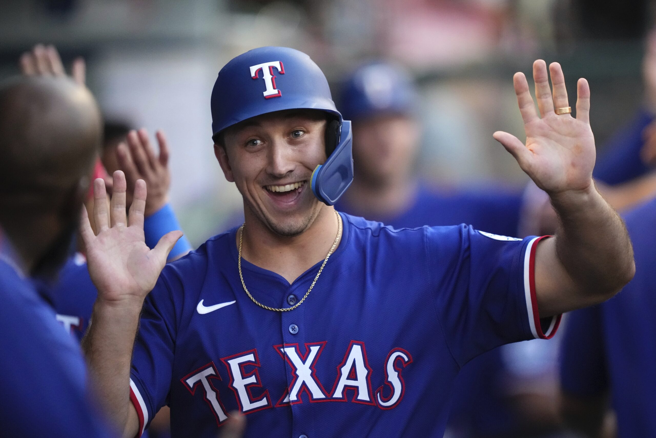 The Texas Rangers’ Wyatt Langford is congratulated by teammates in...