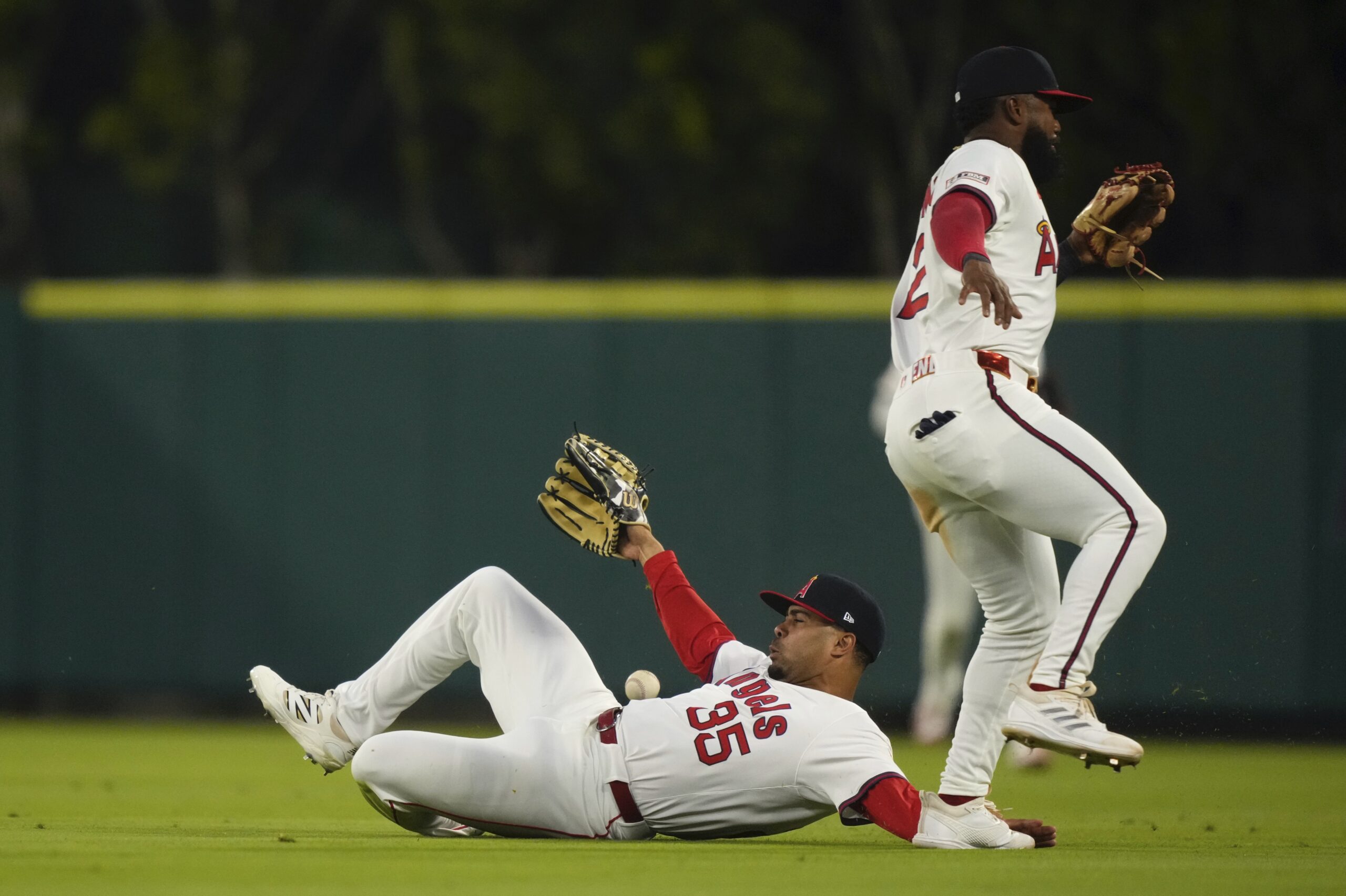 Angels right fielder LaMonte Wade Jr., left, nearly collides with...