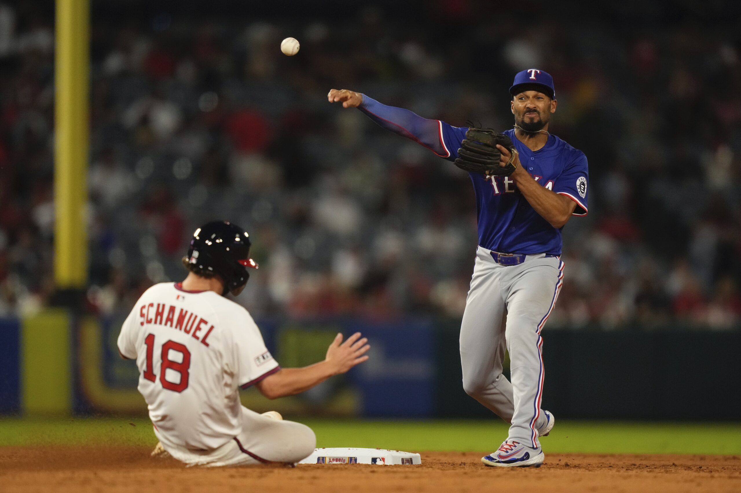 The Angels’ Nolan Schanuel, left, is forced out at second...