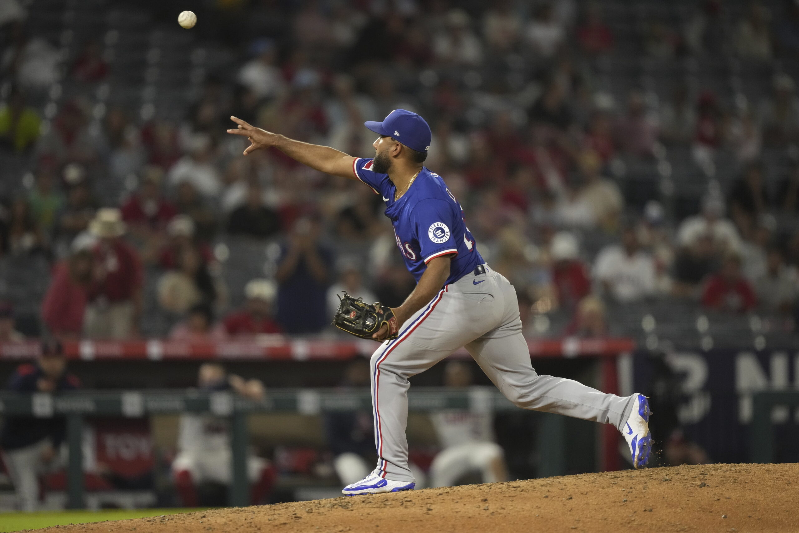 Texas Rangers position player Ezequiel Duran pitches during the ninth...