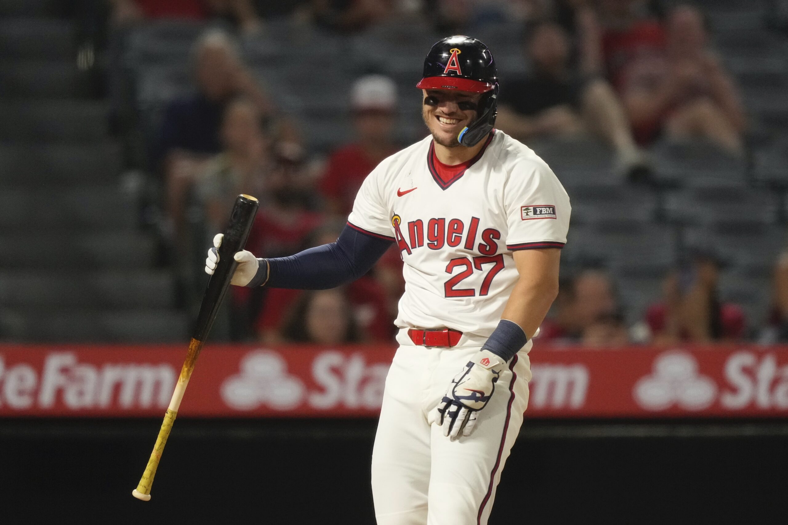 Angels star Mike Trout smiles after taking a pitch from...