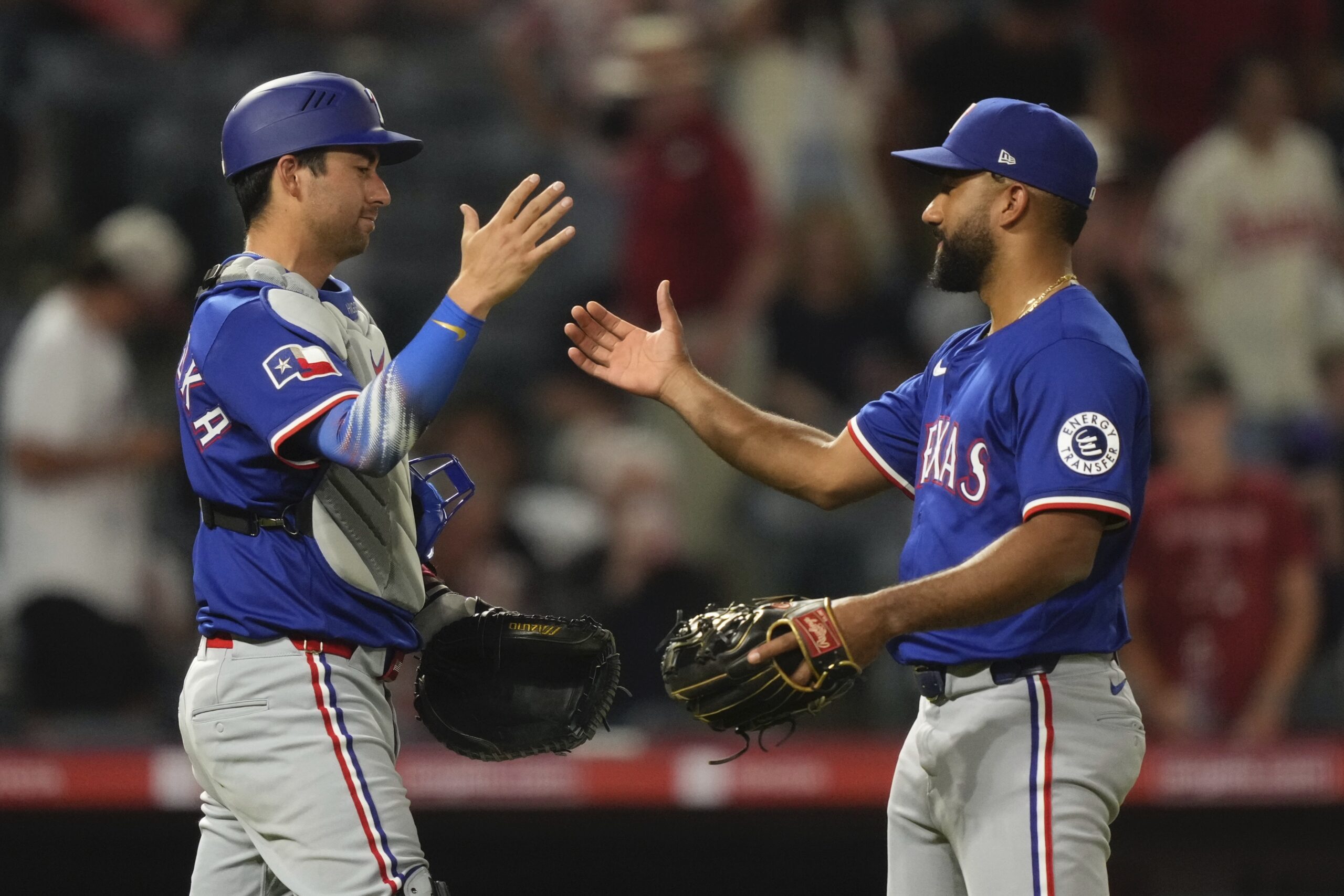 Texas Rangers catcher Kyle Higashioka, left, and relief pitcher Ezequiel...