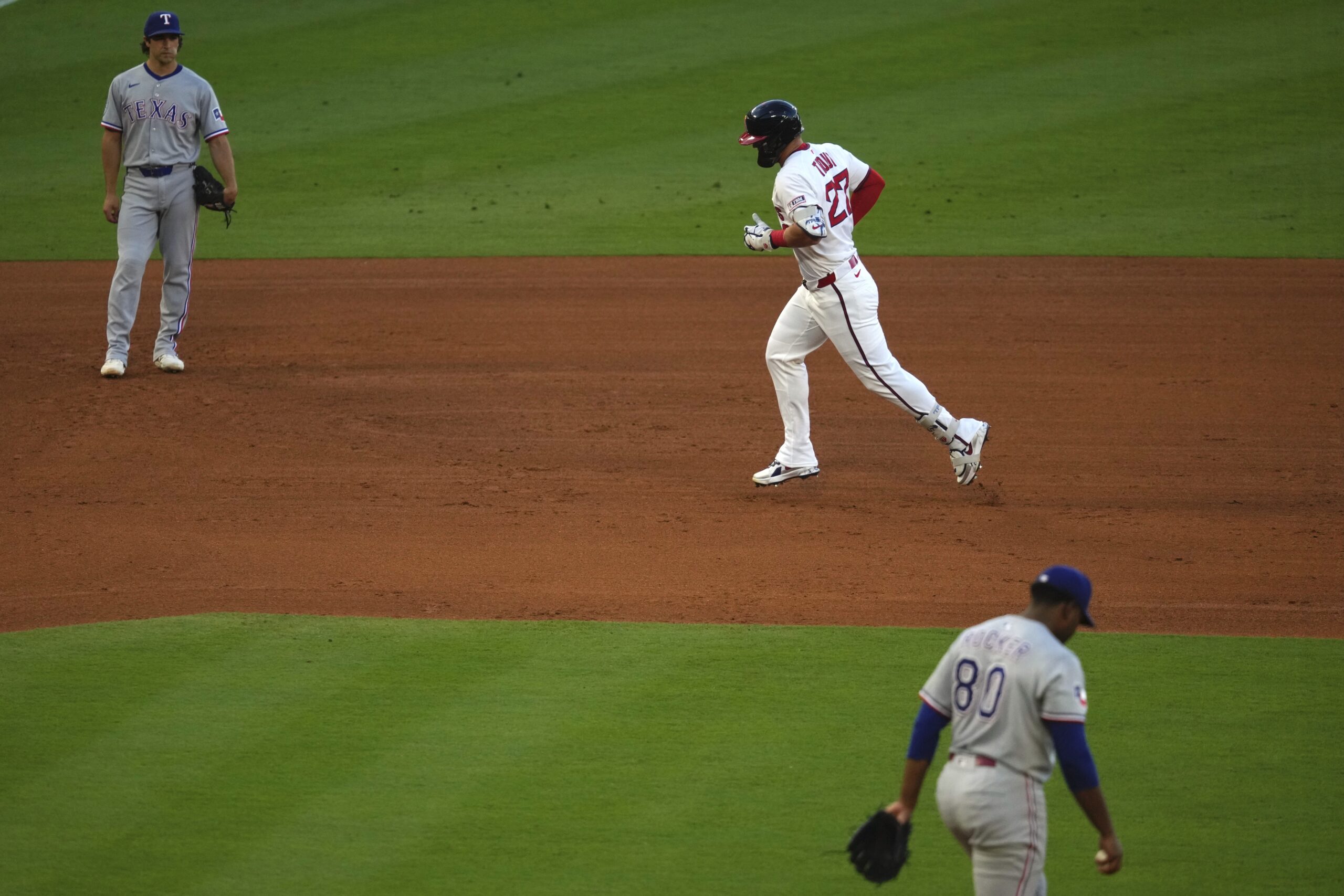 Angels star Mike Trout, center, runs the bases after hitting...