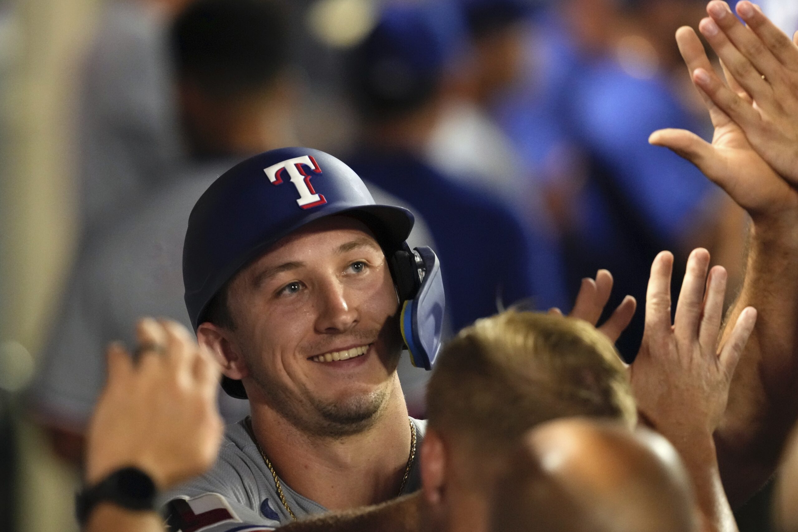 The Texas Rangers’ Wyatt Langford is congratulated by teammates in...
