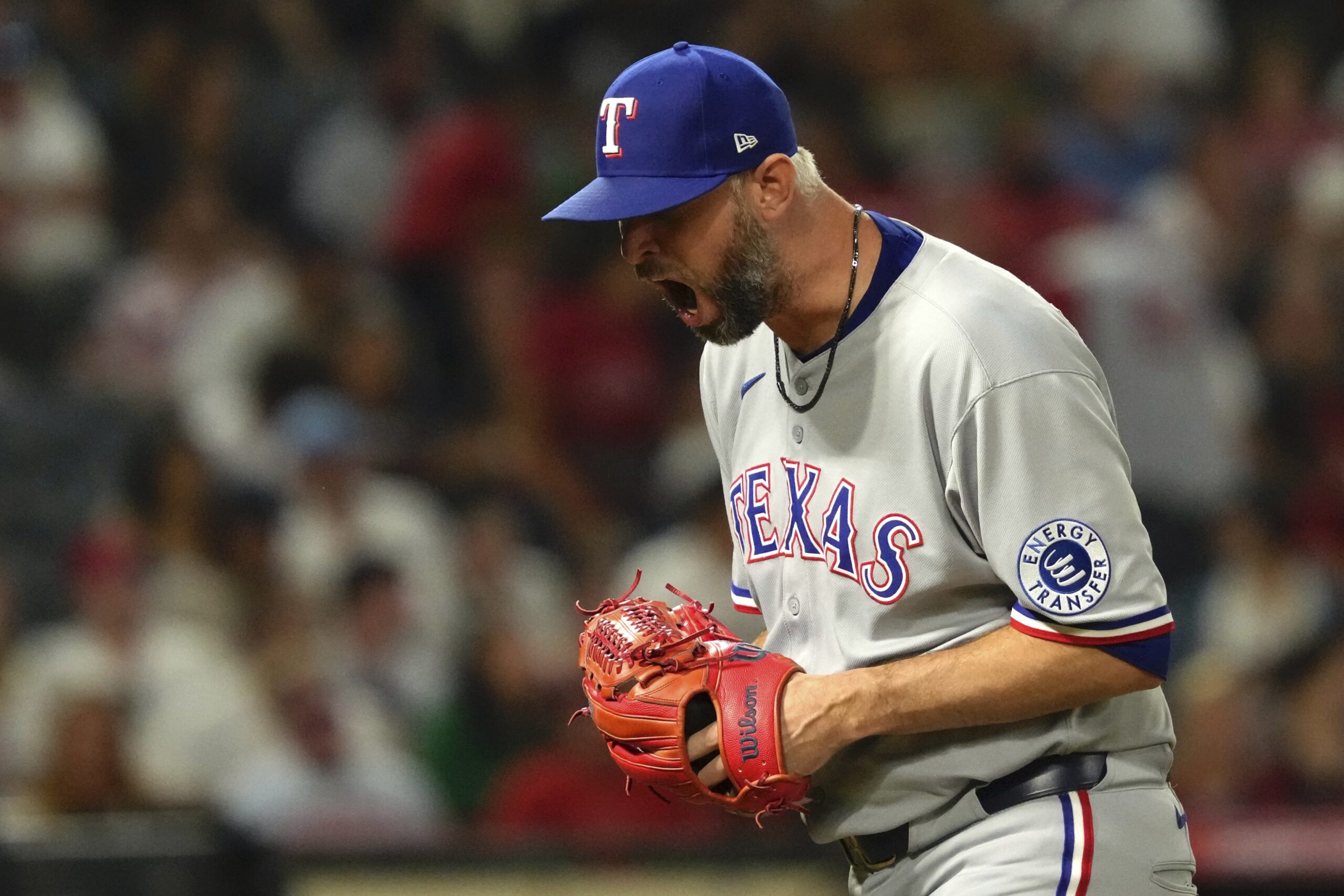 Texas Rangers relief pitcher Chris Martin yells as he walks...