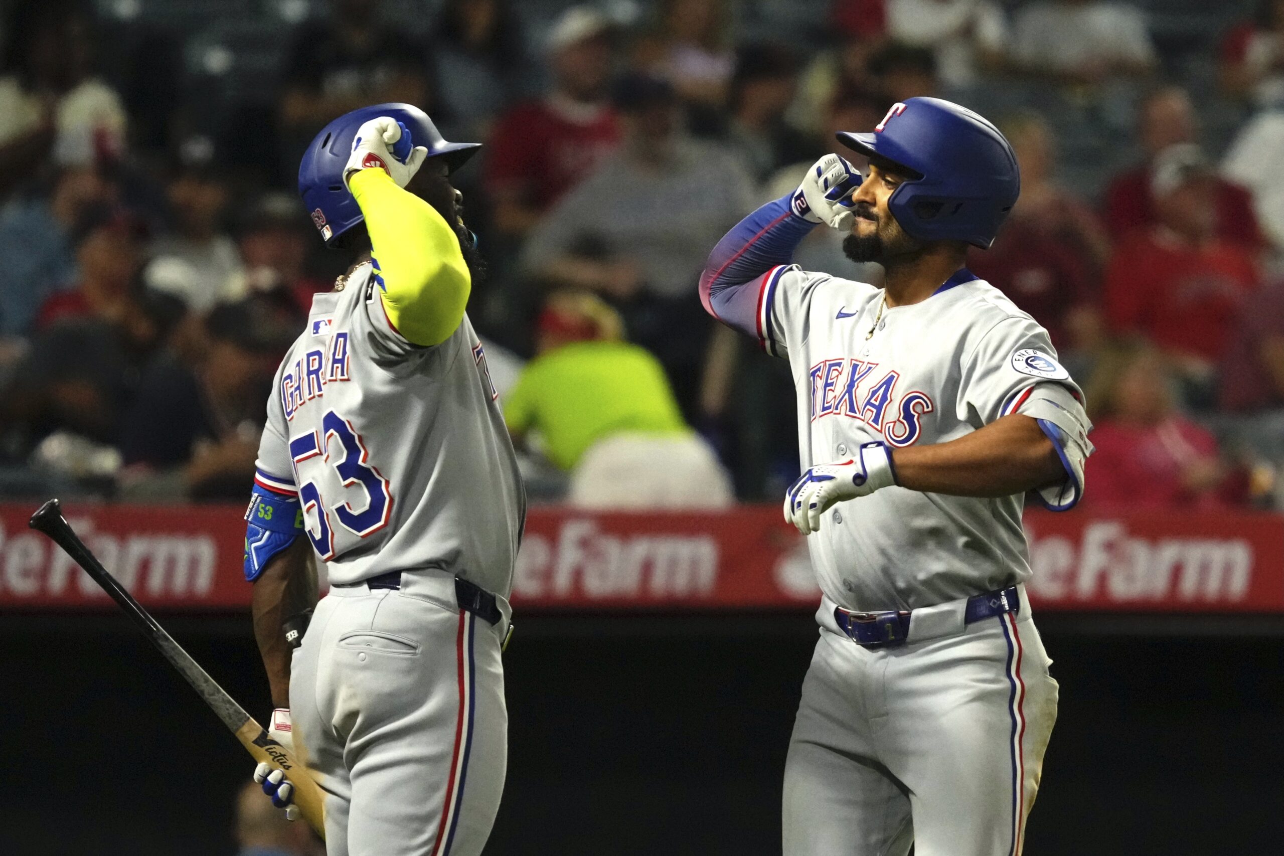 The Texas Rangers’ Marcus Semien, right, is congratulated by teammate...