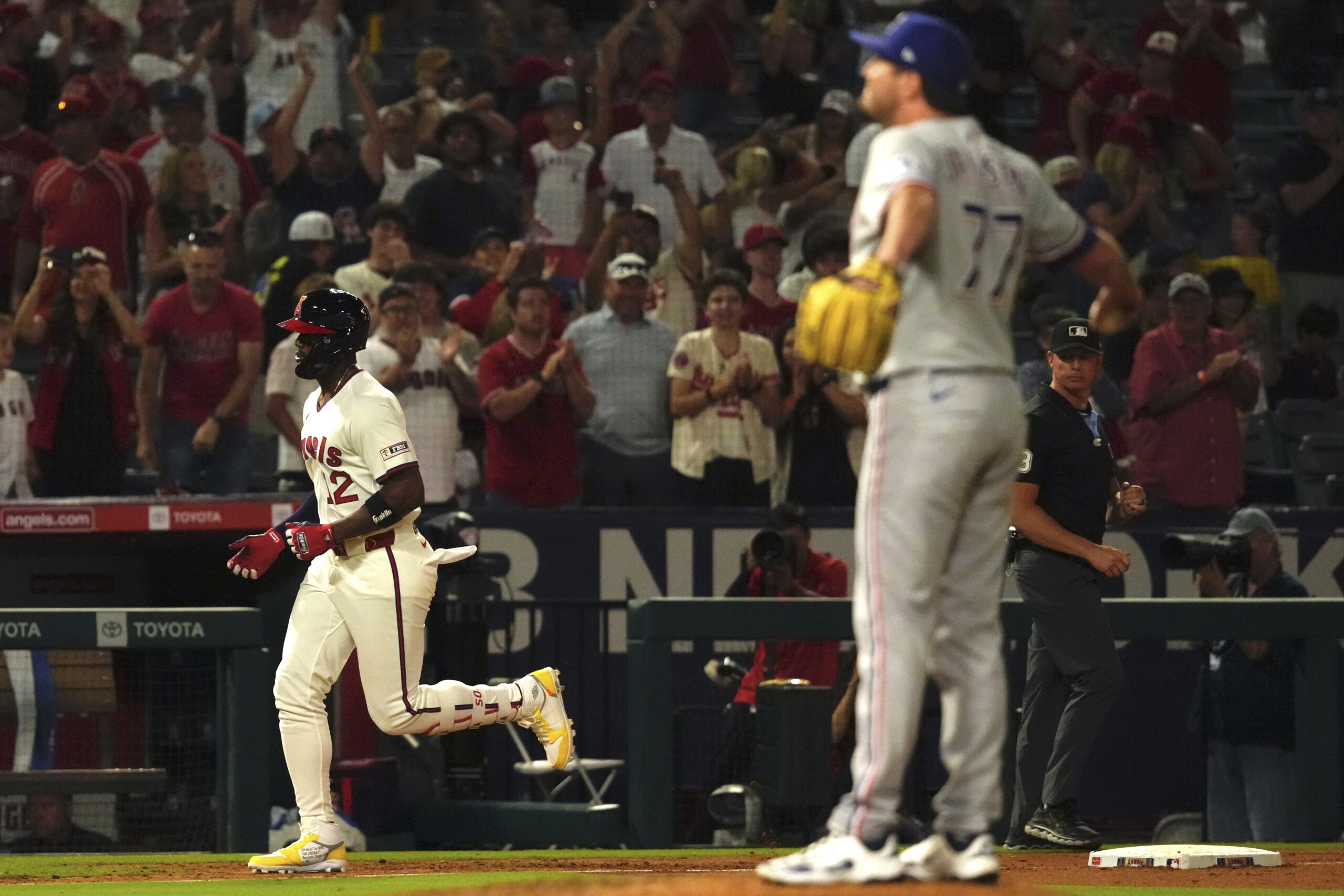 The Angels’ Jorge Soler, left, trots home after hitting a...
