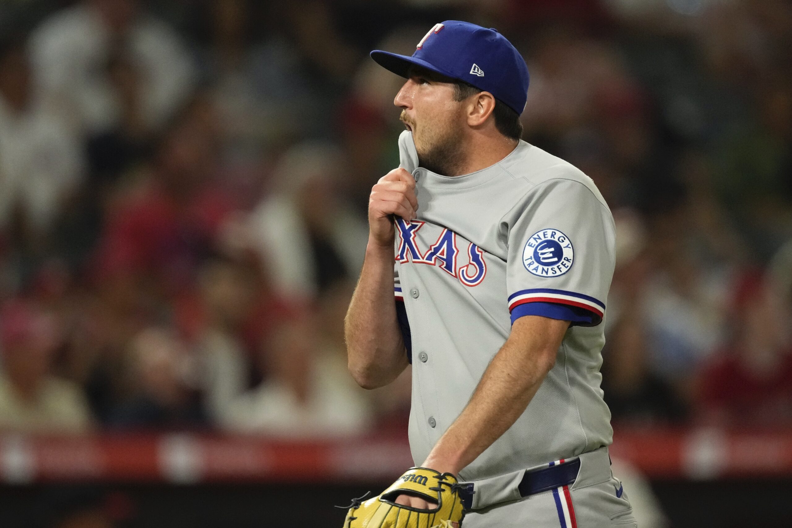 Texas Rangers relief pitcher Luke Jackson bites his jersey as...
