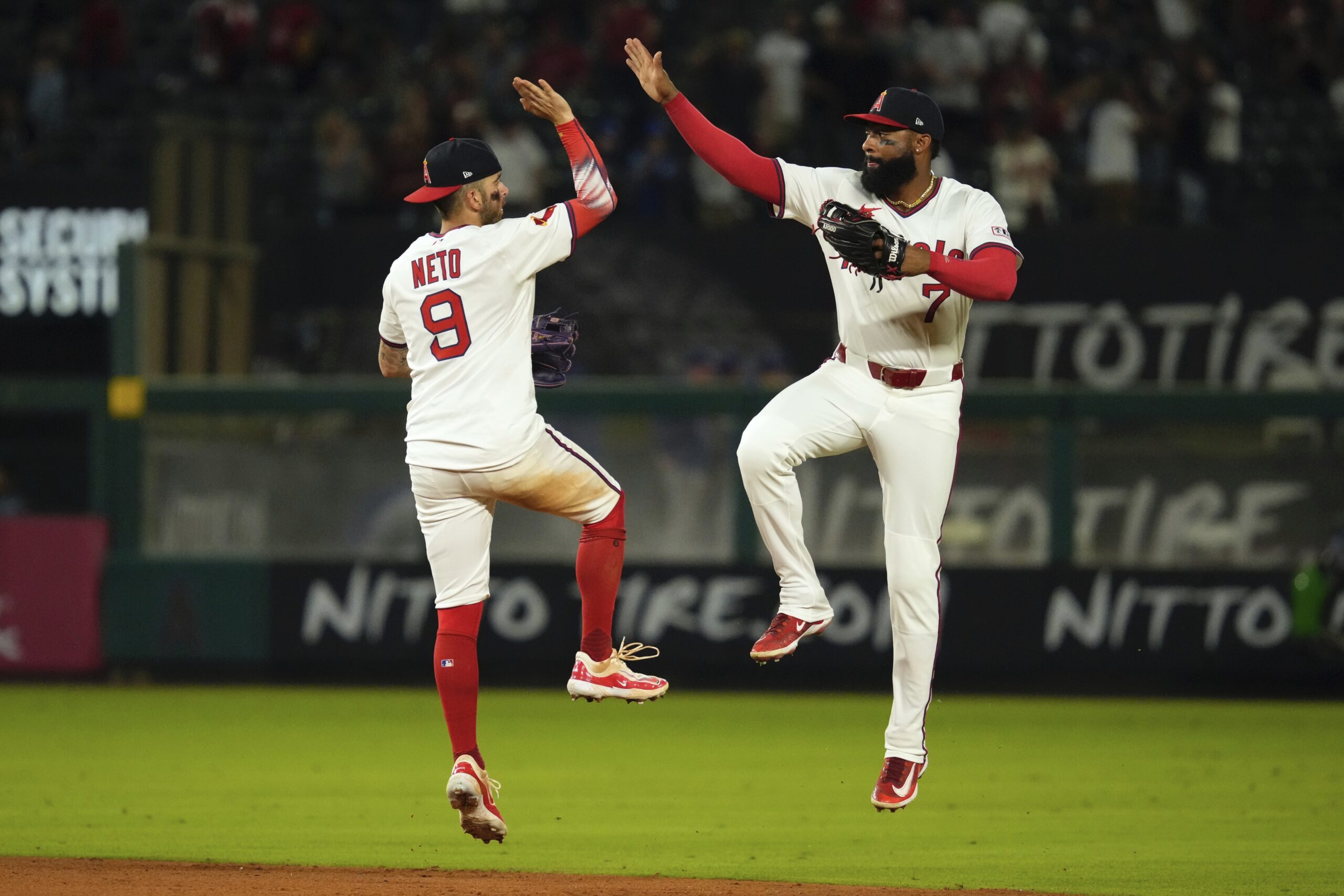 Angels shortstop Zach Neto, left, and center fielder Jo Adell...