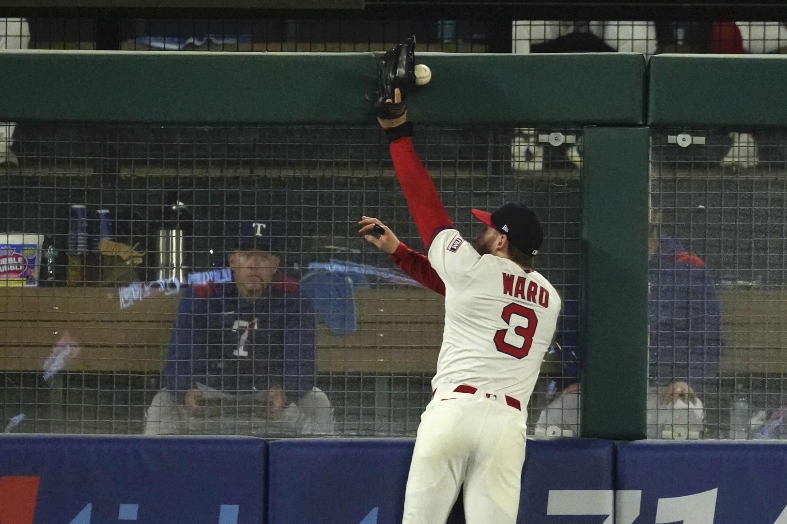 Angels left fielder Taylor Ward can’t handle a ball hit...