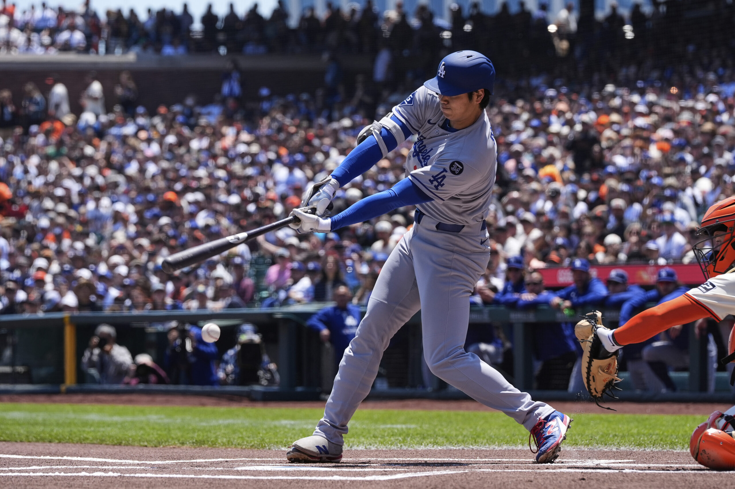 Los Angeles Dodgers’ Shohei Ohtani hits a grounder to San...