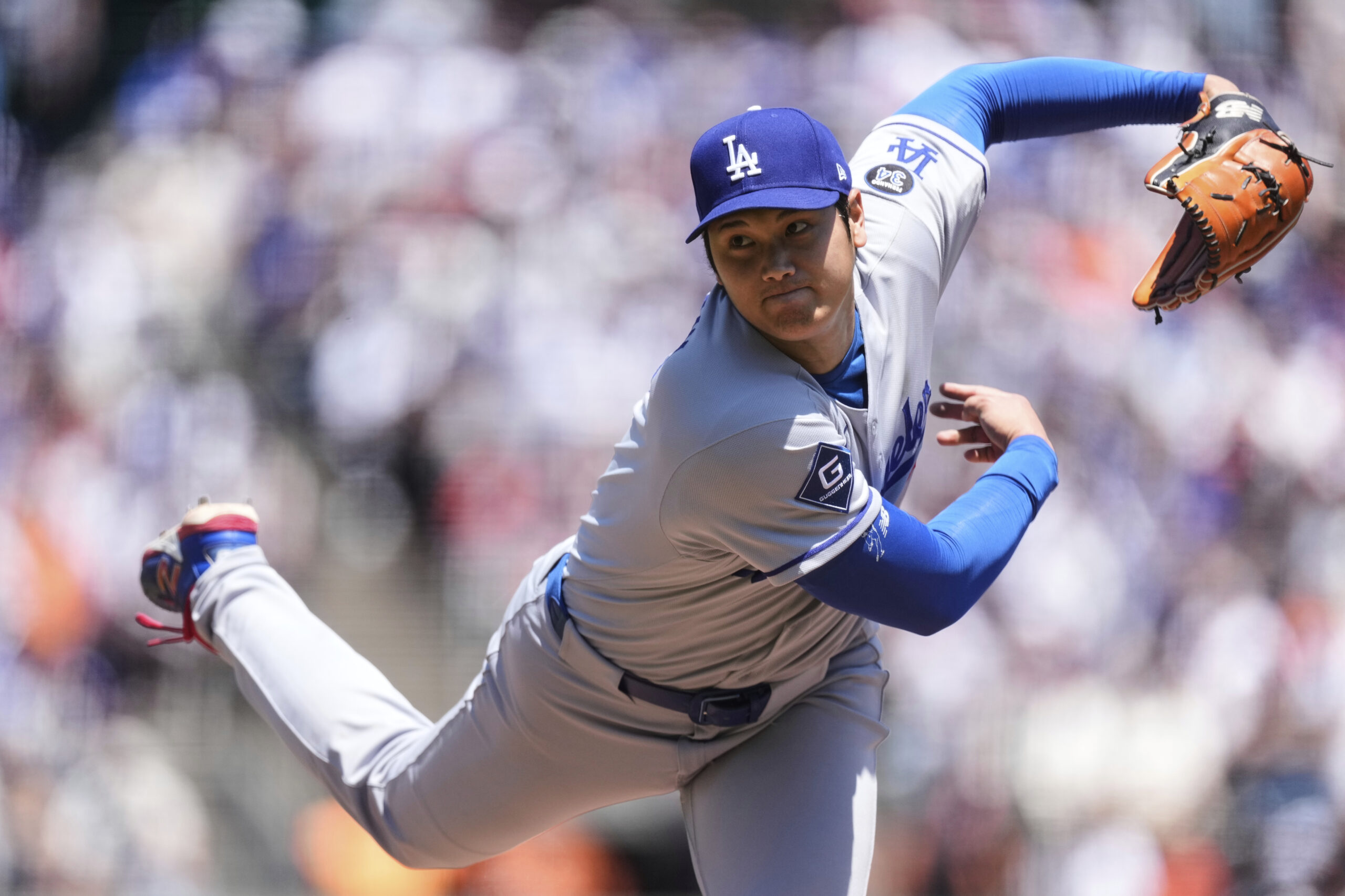 The Dodgers’ Shohei Ohtani follows through on his pitch to...