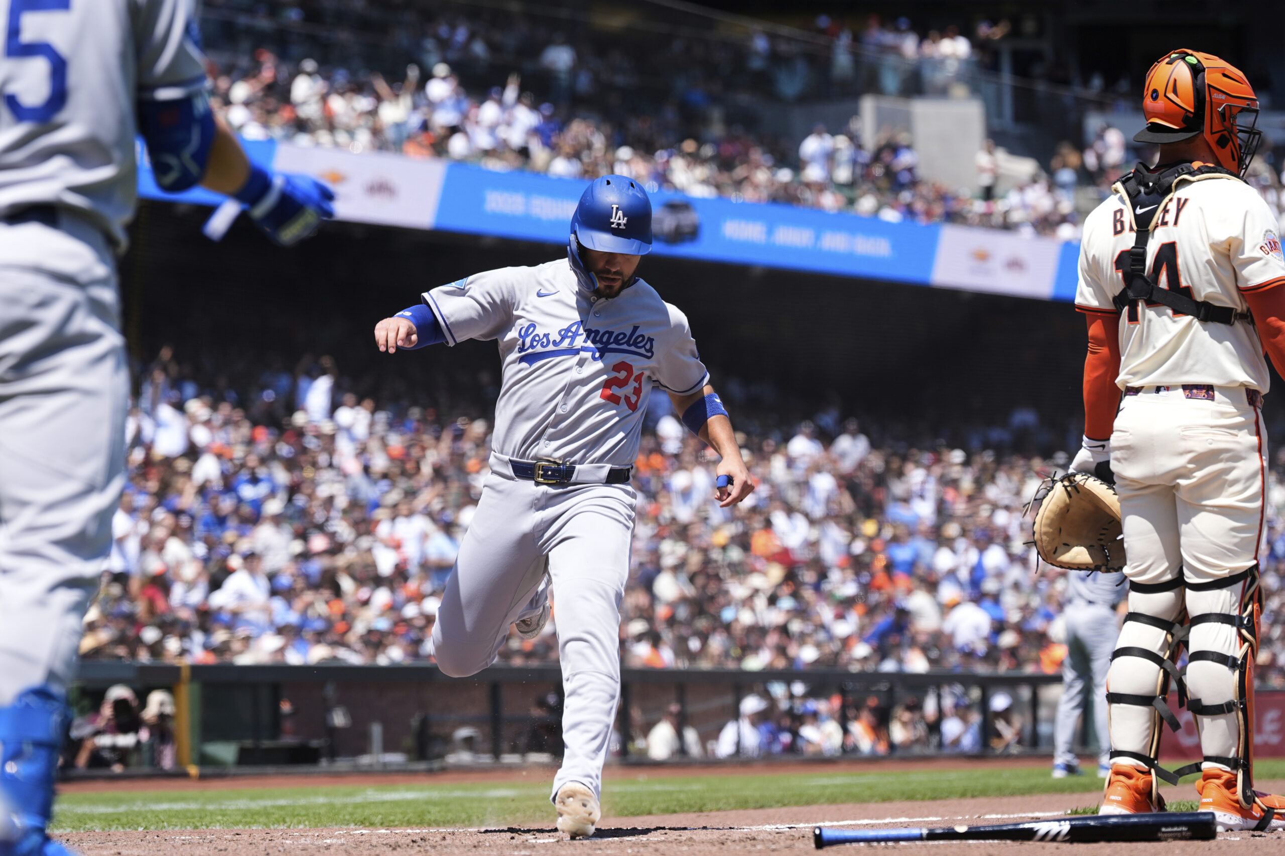 Los Angeles Dodgers’ Michael Conforto (23) scores against the San...
