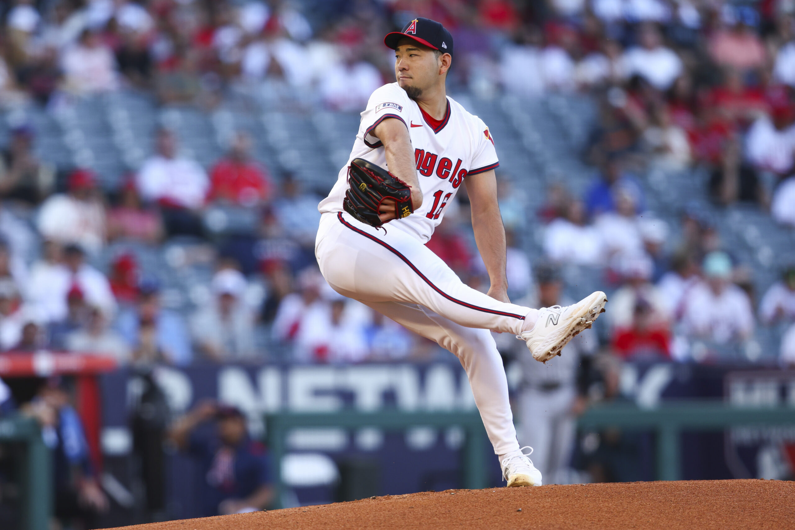 Angels pitcher Yusei Kikuchi prepares to throw to a Arizona...