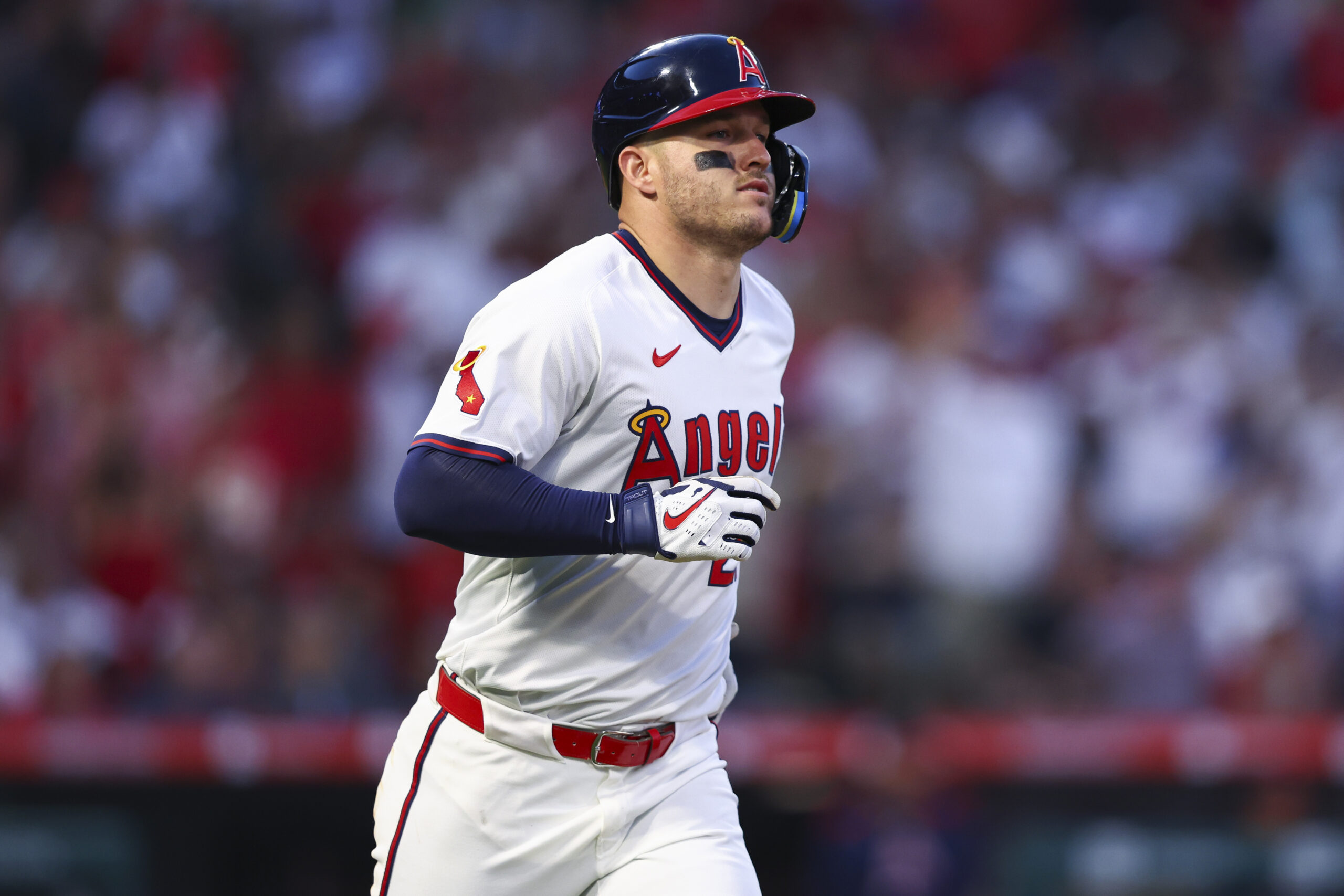 Angels designated hitter Mike Trout runs the bases after hitting...
