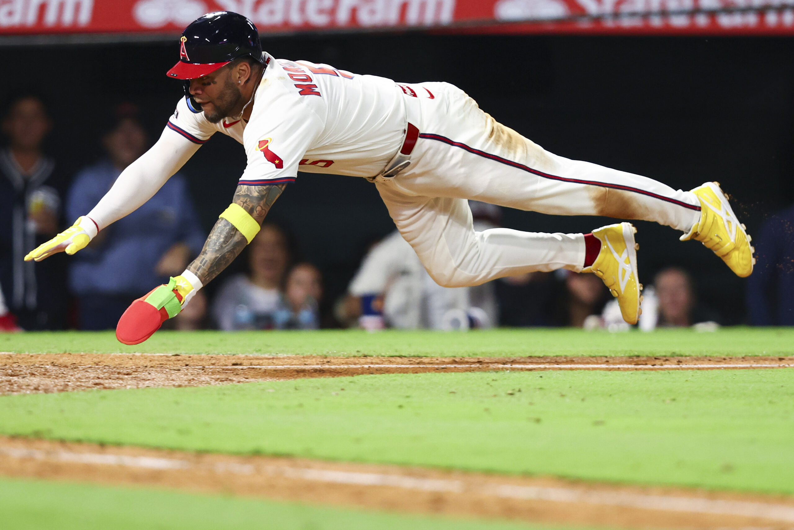 Angels’ Yoán Moncada slides into home plate during the eighth...