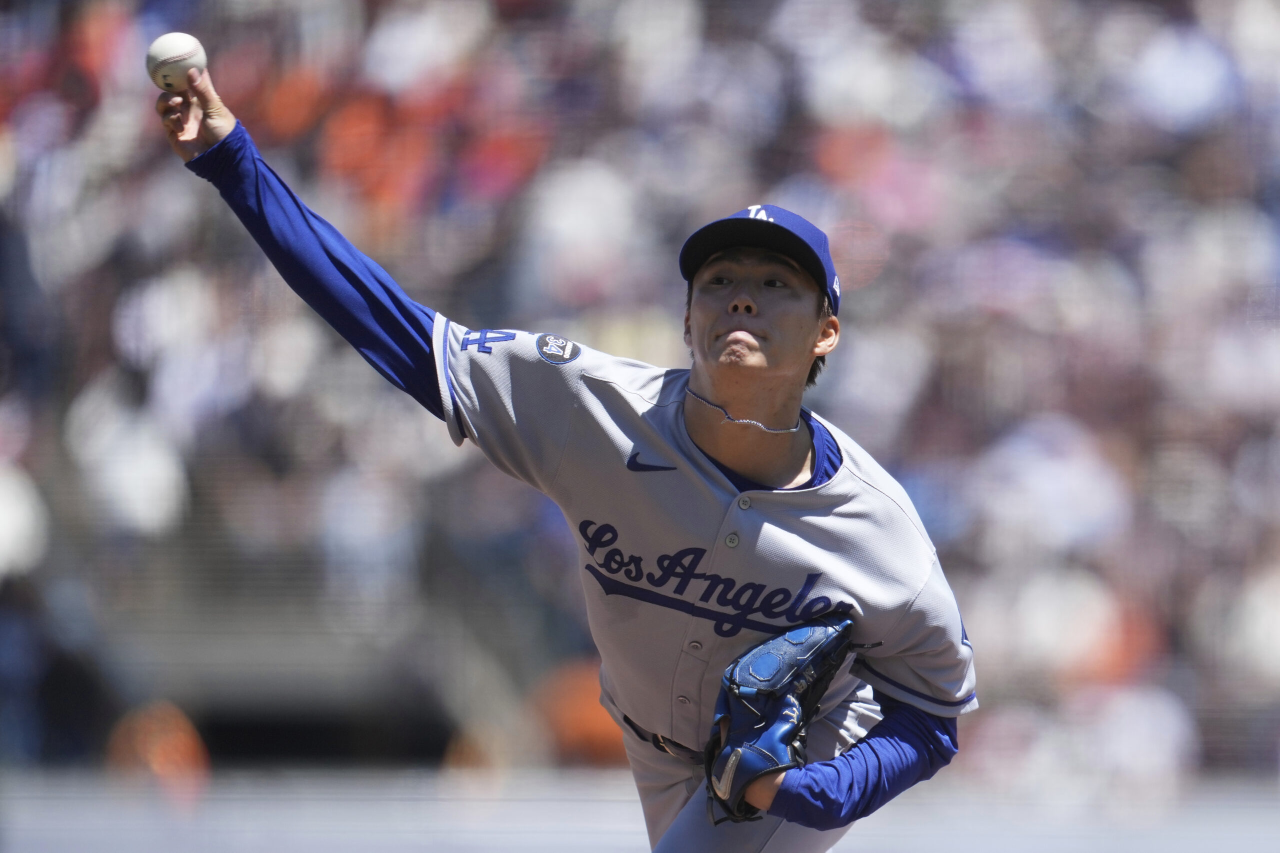 Dodgers pitcher Yoshinobu Yamamoto throws against the San Francisco Giants...